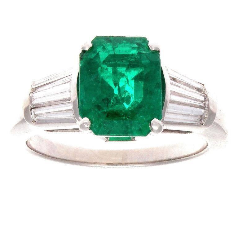 Embracing the ideology of traditional engagement rings while orchestrating a modern flare. Featuring a 2.54 carat emerald that radiates a rich forest green color that collectors lust for. Accompanied with an AGL certificate stating it is of
