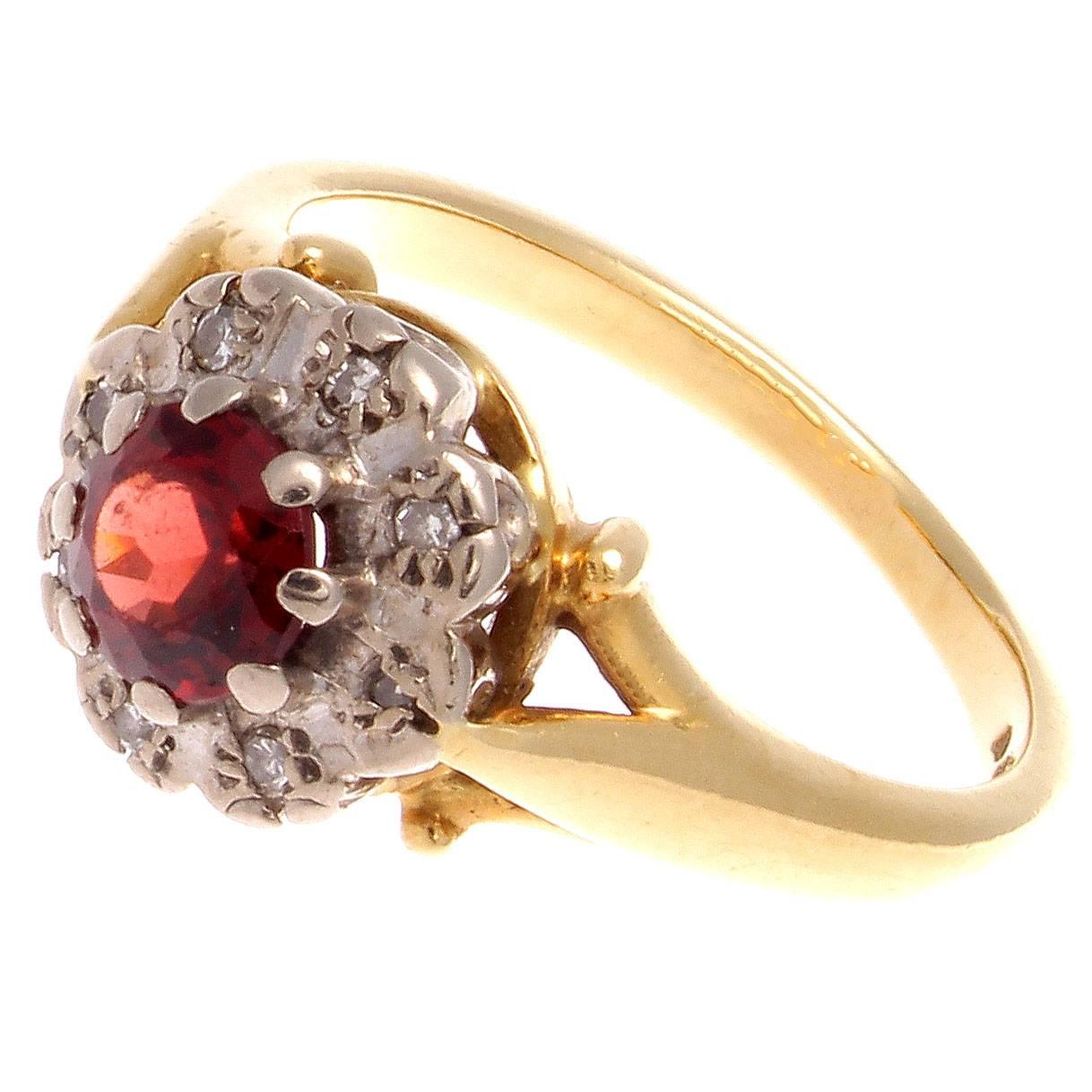 A lovely representation of the romantic period during the Victorian era where bright colors insinuated the love between the king and queen as well as the prosperity in the realm. 

This classic cluster ring features a vibrant orange armadine garnet