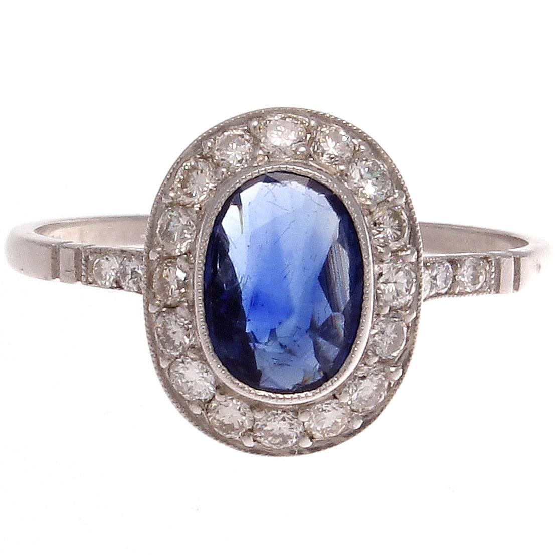 Forever in style, the classic halo ring. Featuring an approximately 1.00 carat deep blue oval cut sapphire elegantly surrounded by a  halo of colorless diamonds. Expertly hand crafted in platinum.

Ring size 7 and may be resized.