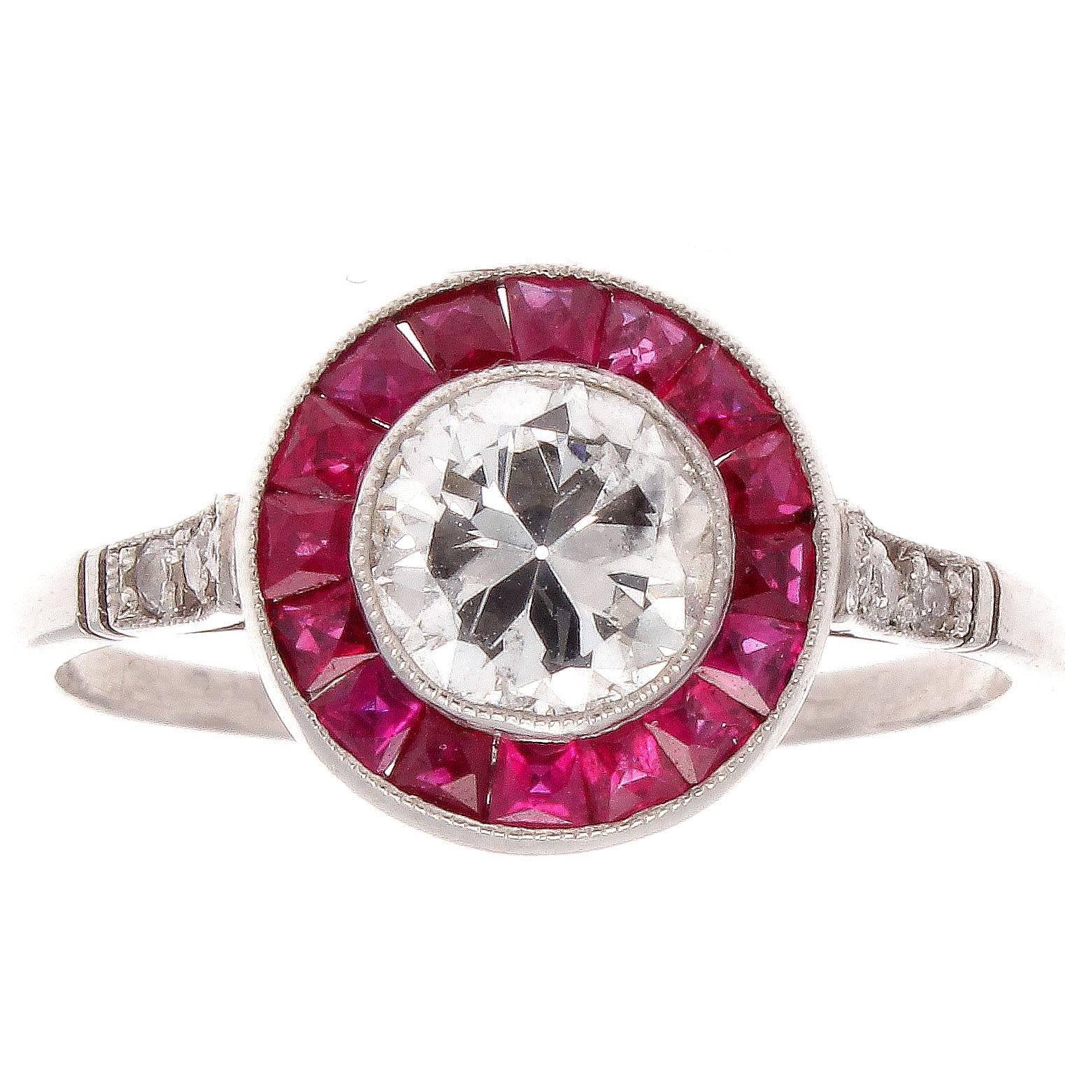 The forever in style halo ring. Featuring a 0.70 carat center diamond that is accompanied with an EGL certificate saying it is G color, VS2 clarity. Surrounded by a halo of vivid red rubies that effortlessly flow into the diamonds cascading down the