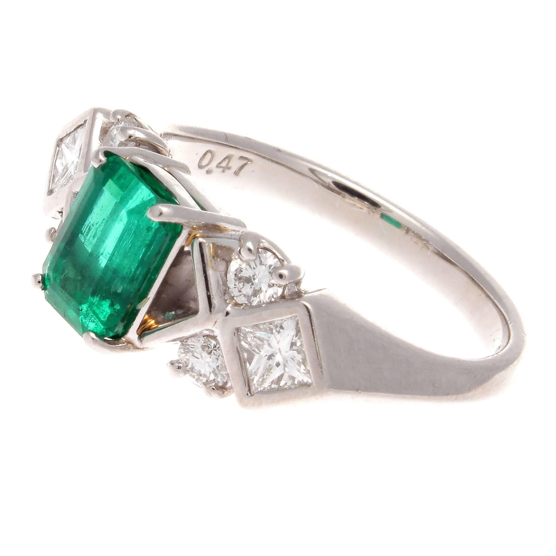 A beautiful modern creation. Infusing eye catching color with eye pleasing symmetrical design. Featuring a 1.06 carat deep forest green Colombian emerald accented by a mixture of square and round cut near colorless diamonds weighing 0.47 carats.