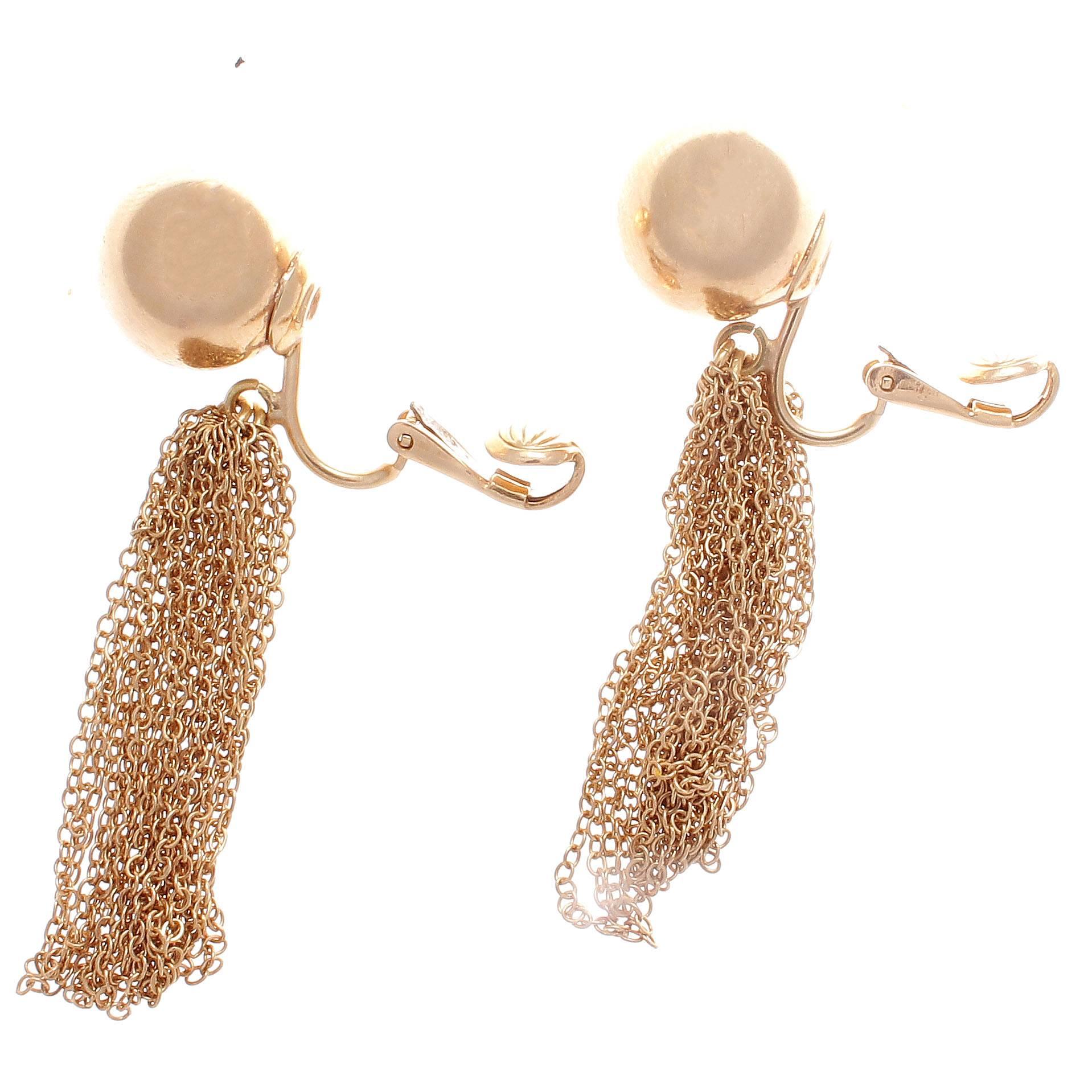 A creative interpretation of the traditional chandelier earring. Long, elegant and freely moving with every step you take. The intricate gold mesh is held by two spheres of glistening 14k gold. 