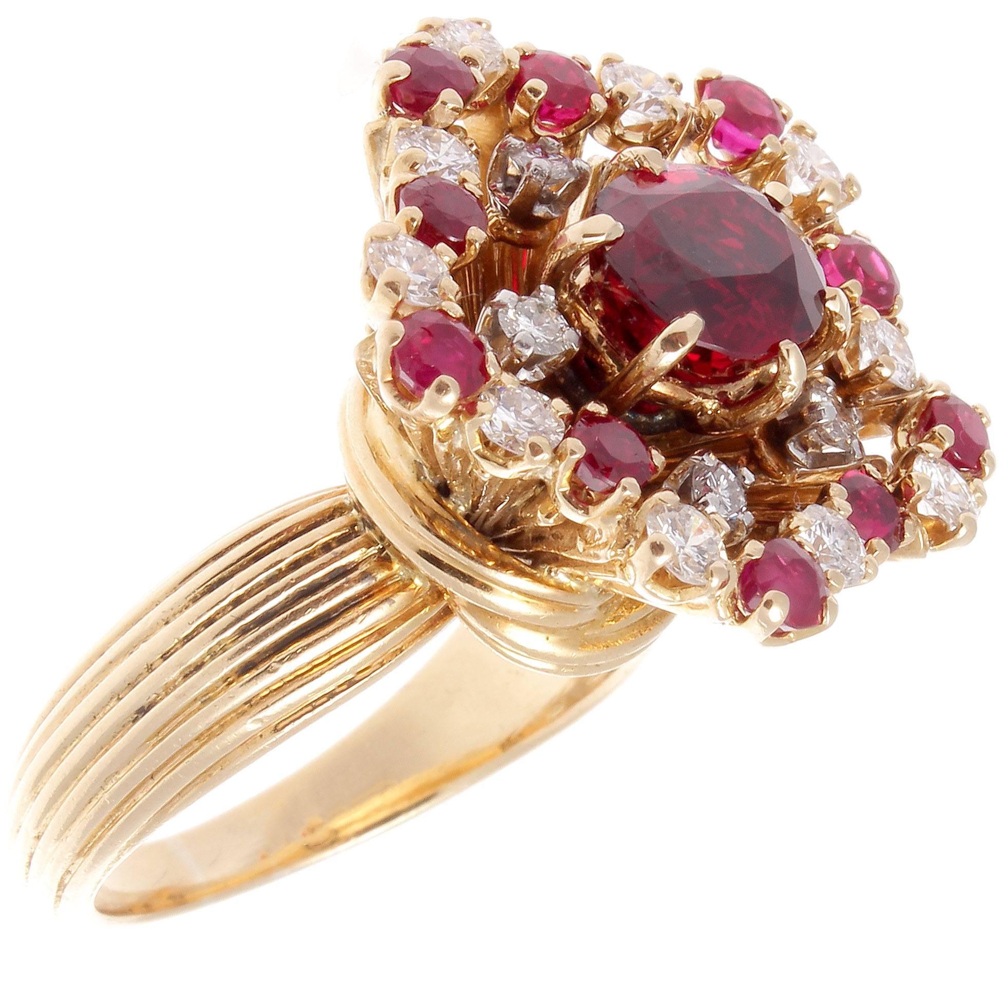 A burst of color radiates from this retro creation that embraces everything the 1940's represented. Featuring a 1.85 carat vibrant translucent gem red ruby. Accented by a spray of perfectly matching vivid red rubies and colorless diamonds to form