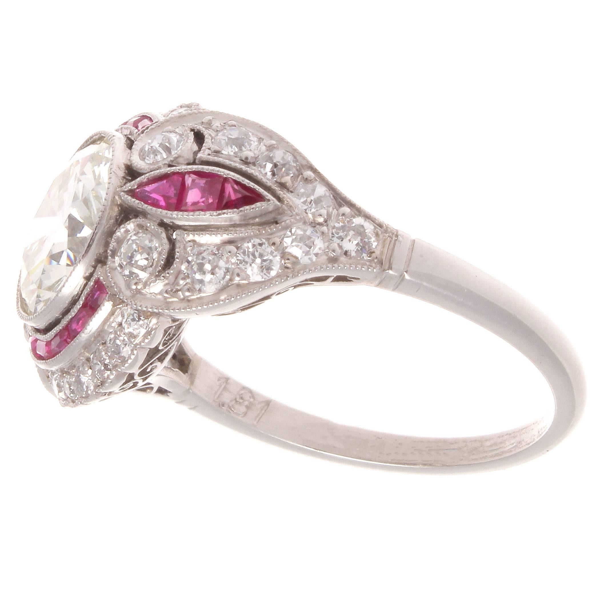 A swirling symphony of color and form. The round cut 1.81 carat diamond is I color and VVS clarity. The accenting diamonds are near colorless and the richly colored rubies add color and vibrancy.

Ring size 6 1/2 and may easily be re-sized to fit.