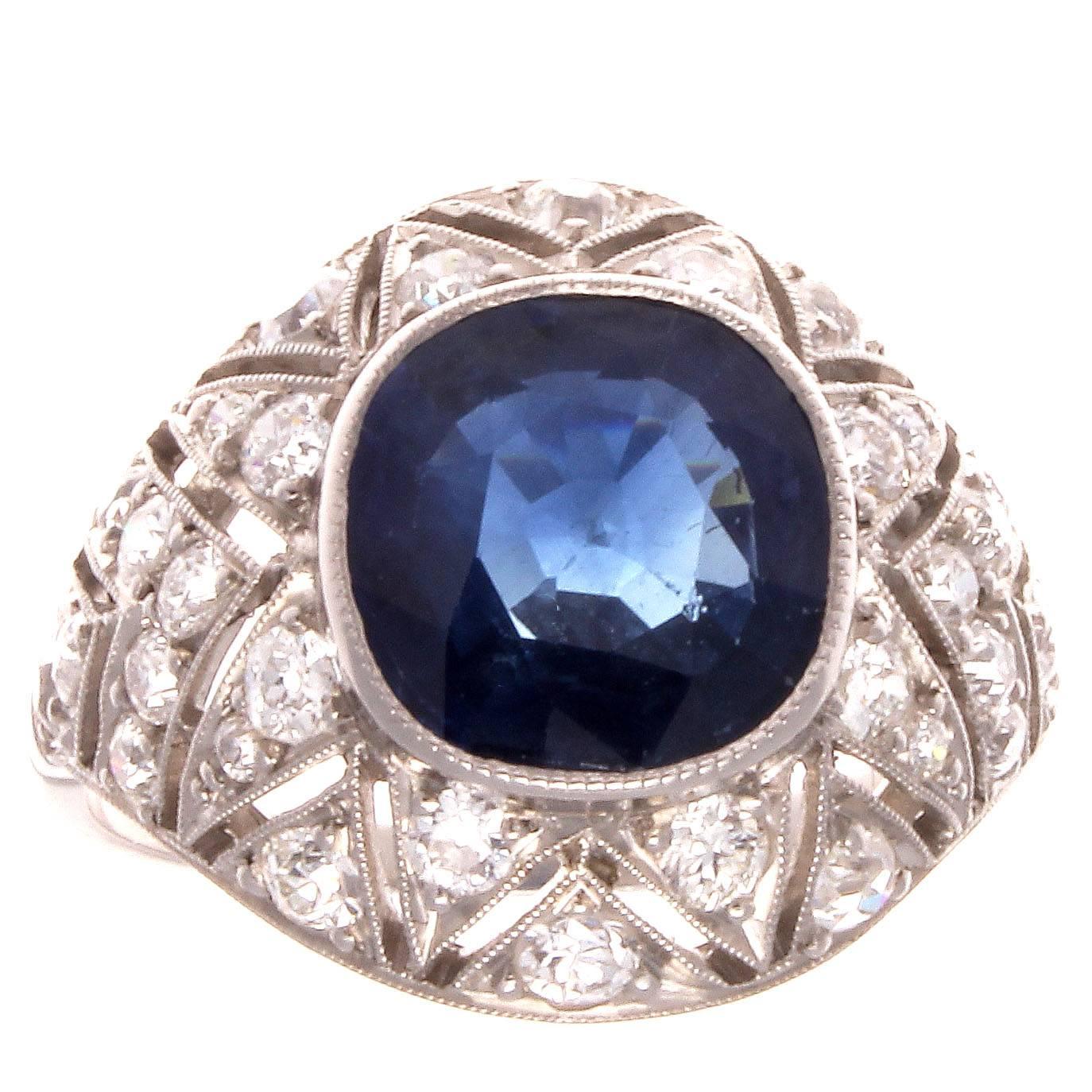 A nice blue Sapphire set in an intricately hand made filigree platinum ring with white diamond accents. 

Ring size 6 1/2 and may be re-sized to fit.
