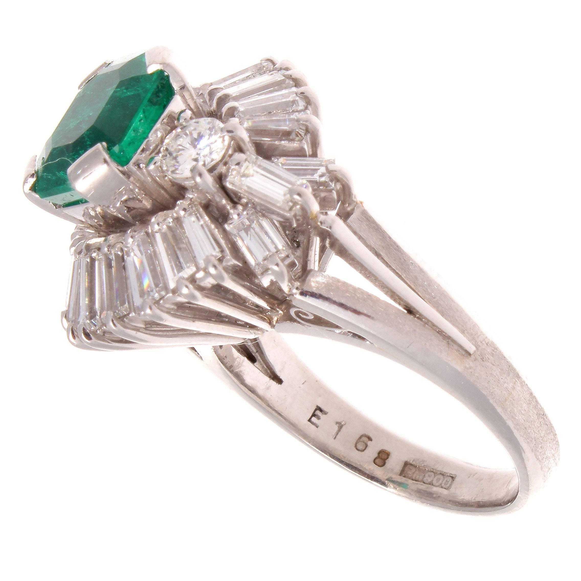 Featuring a bed of white diamonds weighing approximately 1.60 carats showcasing and highlighting the lively 1.68 carat forest green emerald. A dramatic ring and made of platinum.

Ring size 5 1/2 and may be re-sized to fit.