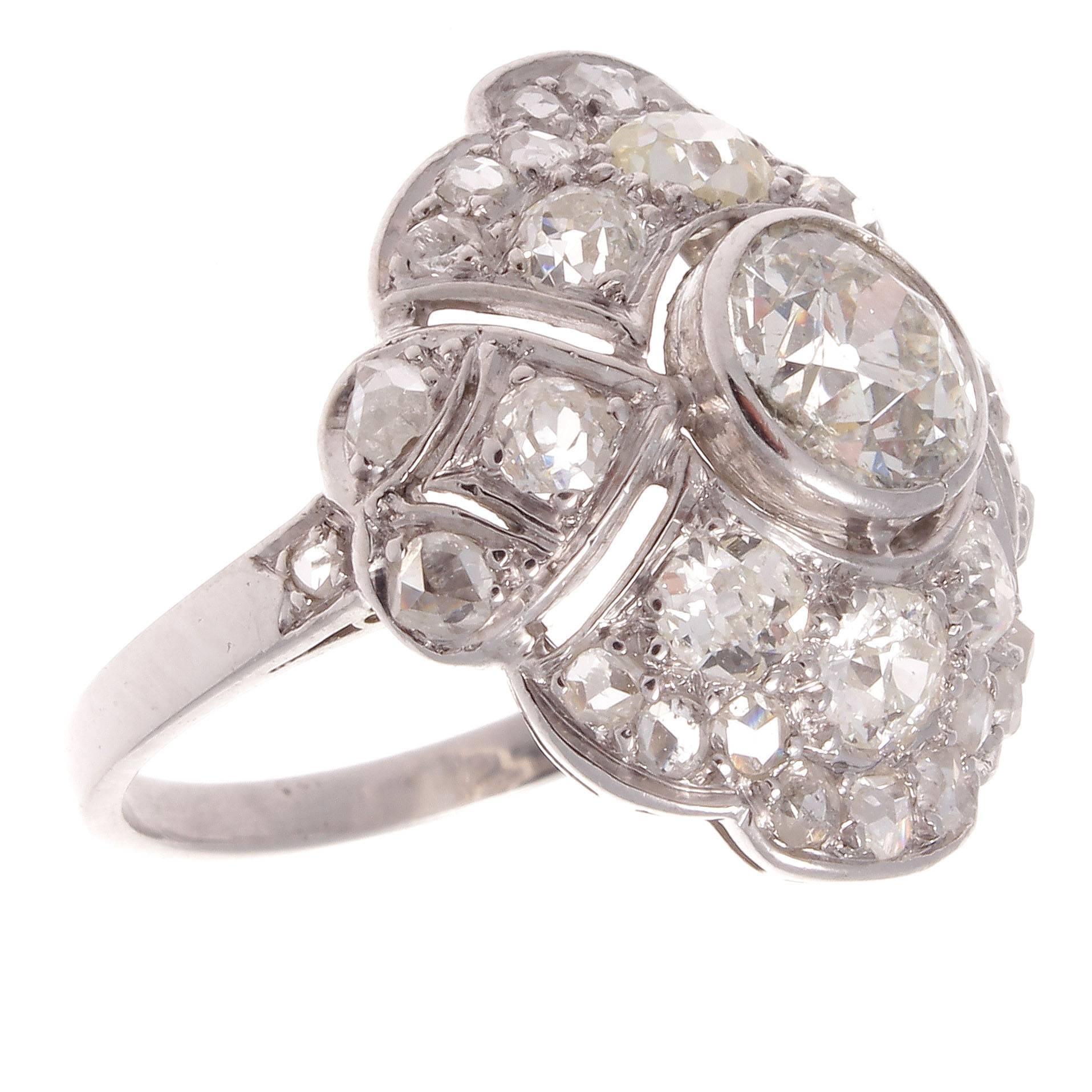 A well balanced geometric interpretation of the classic diamond cocktail ring. Featuring an old European cut diamond weighing approximately 0.90 carats that is G color, SI2 clarity with accenting diamonds weighing approximately 1.25 carats. The well