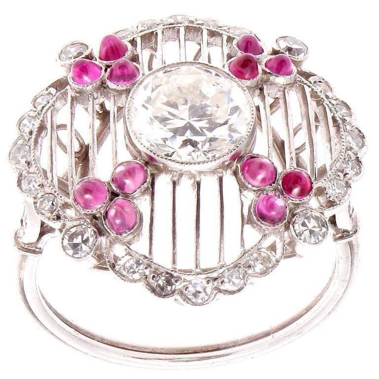 A creation of true excellence inspired by the historic Art Deco period. Featuring a 1.08 carat round brilliant diamond that is E-F in color SI+ in clarity. The diamond is centrally placed in a vertical mesh basket that is decorated with vibrant red