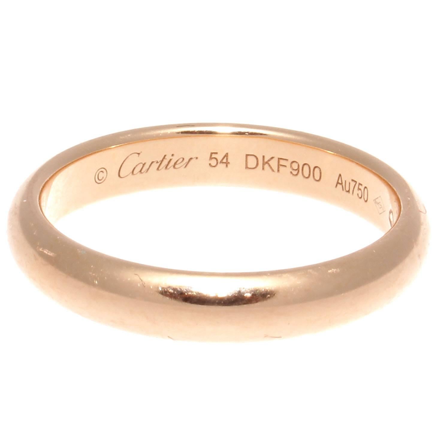 The Cartier gold band is in 18k gold, signed Cartier, serial number DKF900 and French size 54 which is U.S. 7. 