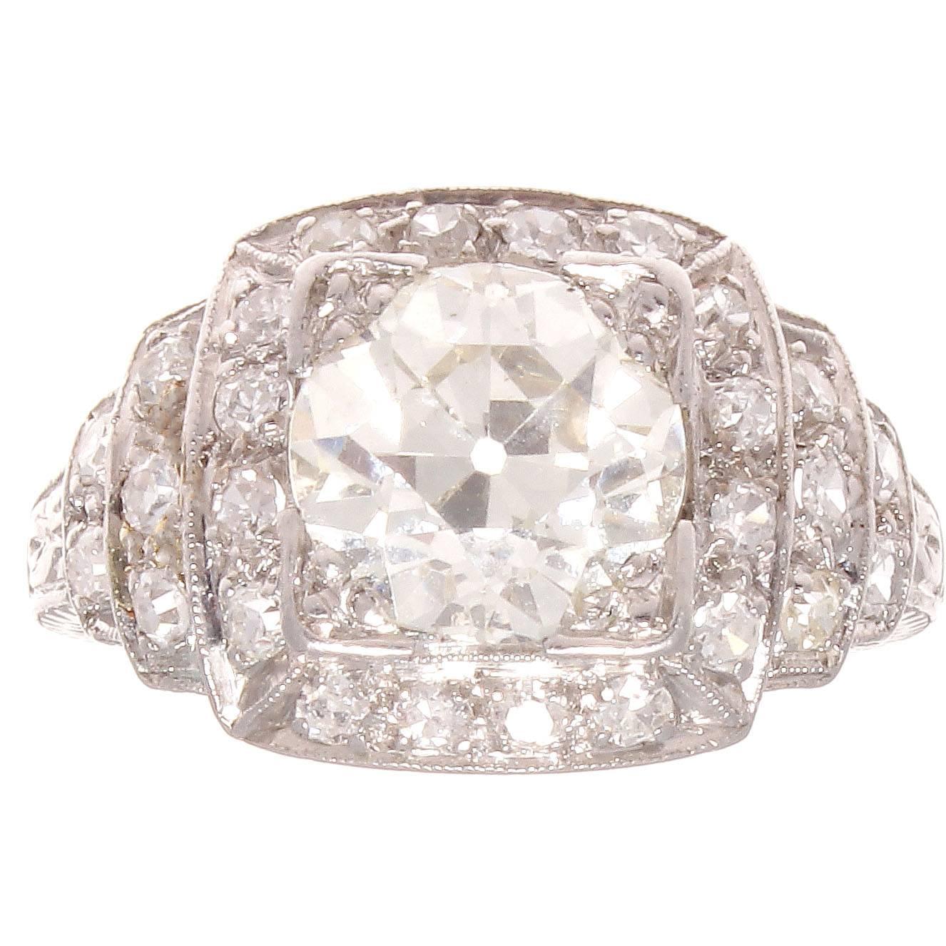 Created as an architectural themed diamond ring. The original art deco design features an old European cut diamond of 1.92 carats and numerous white diamonds as a halo as well as accents. The center diamond is graded as L color and VS clarity. 

The
