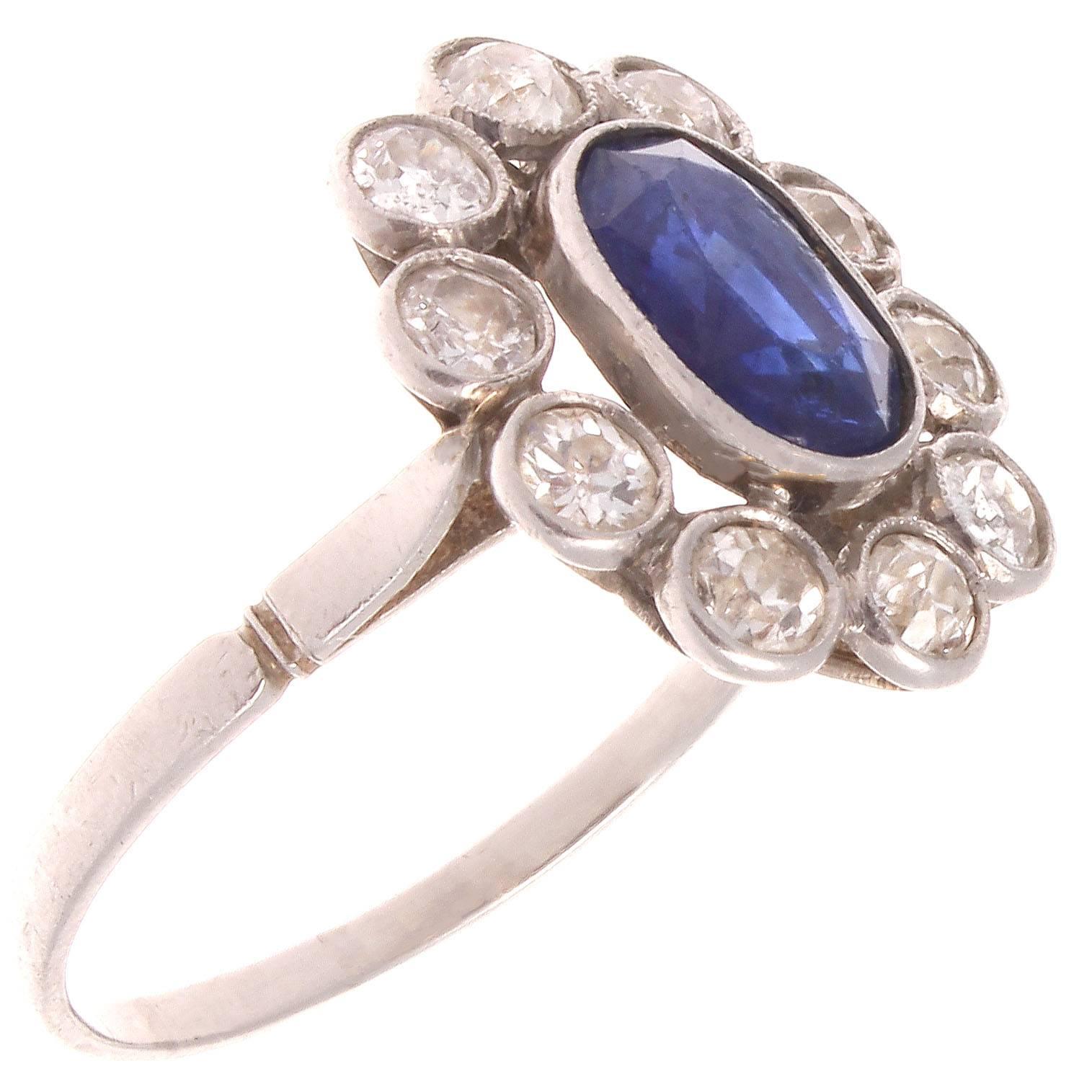 A very pleasing blue emanates from the natural sapphire weighing approximately 2 carats. The blue is perfectly complimented and highlighted by the halo of 10 white diamonds weighing approximately 1.50 carats. The hand crafted ring is in 18k white