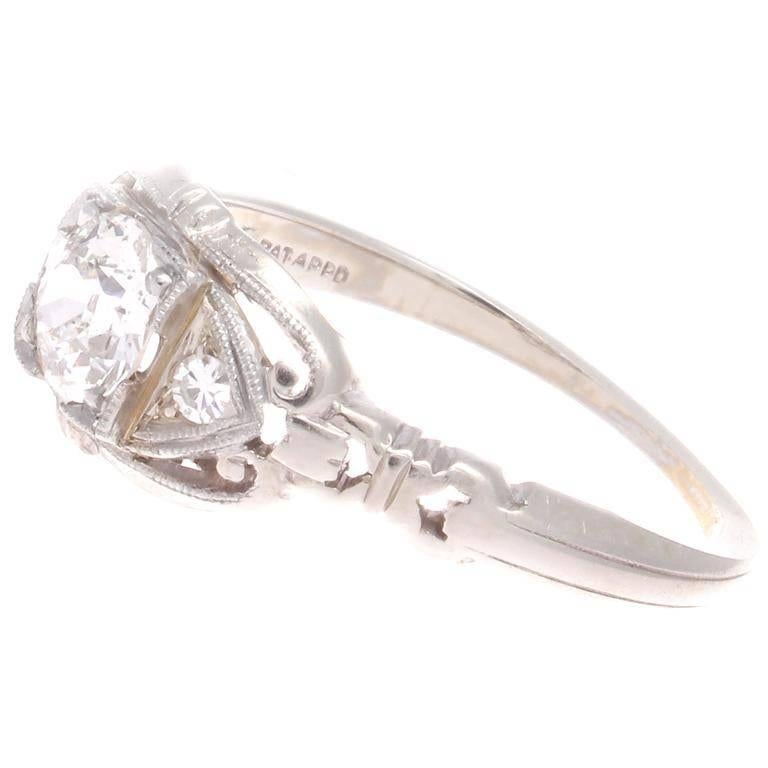 Featuring distinct lines of architectural design evolving around the diamonds to form this graceful engagement ring.  Created with an approximately 0.45 carat white, clean center diamond that has been hand crafted in 18k white gold. 

Ring size 6