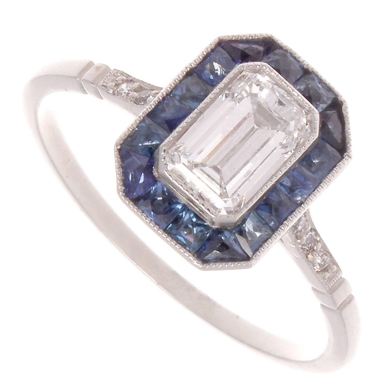 A special hand made ring for that special someone. Featuring a 0.68 carat emerald cut diamond that is F color, SI2 clarity. Surrounded by a vibrant halo of navy blue sapphires. Crafted in platinum.

Ring size 7 and may easily be resized.