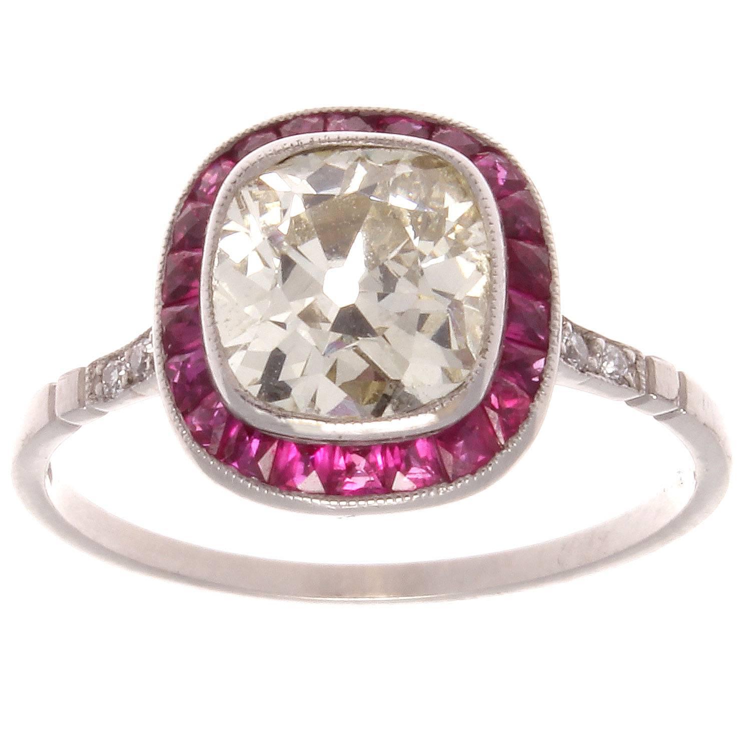 The halo setting is currently the most popular designed engagement ring. The creative use of rubies instead of diamonds gives the ring an added attractive dimension. Featuring an expertly cut 1.64 carat old cushion diamond that is L, M color and VS1