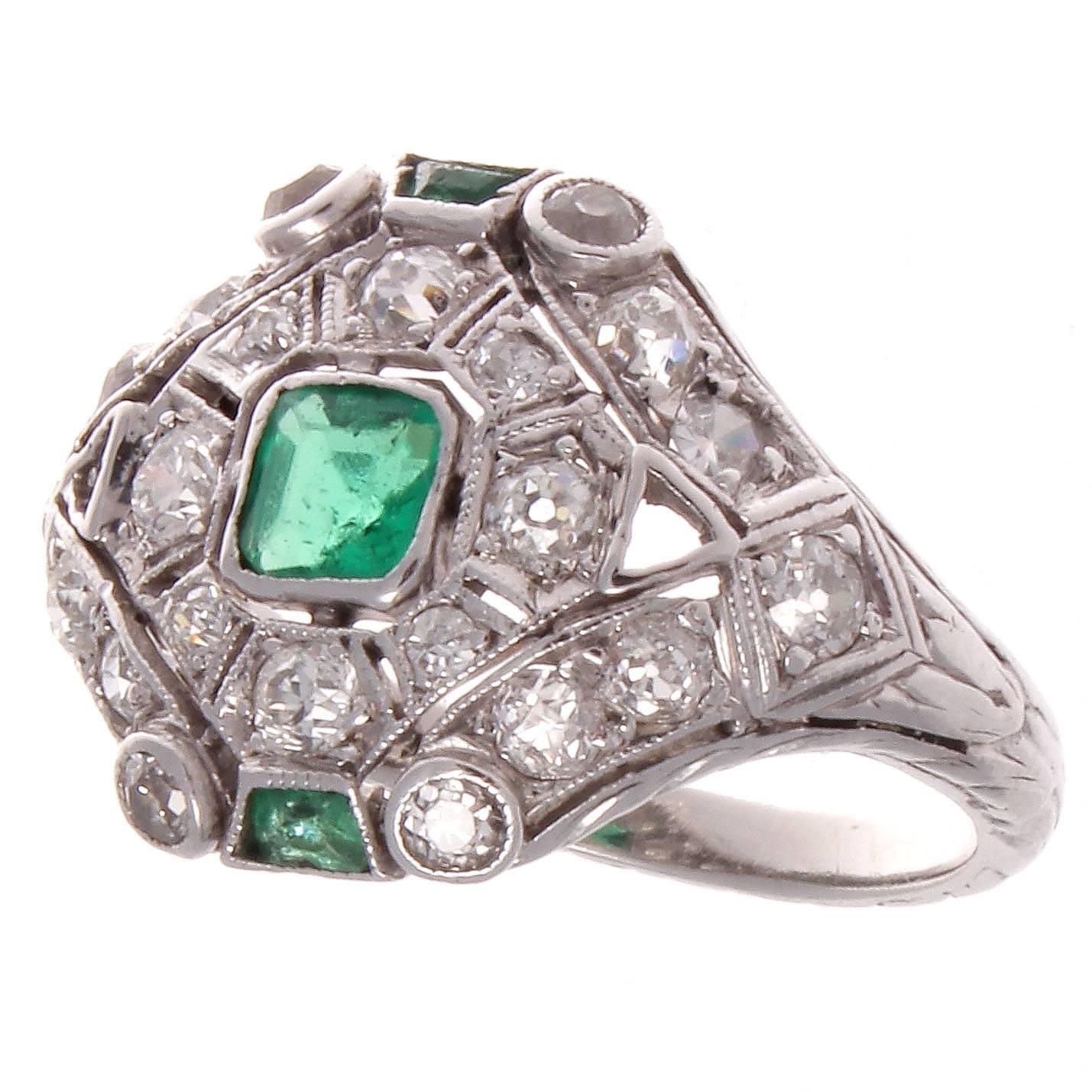 Intricate design that is expertly hand crafted. Exhibiting all techniques that made the art deco time period unforgettable. Featuring vivid green emeralds and perfectly placed white diamonds all set in the platinum ring.

Ring size 6 and may be