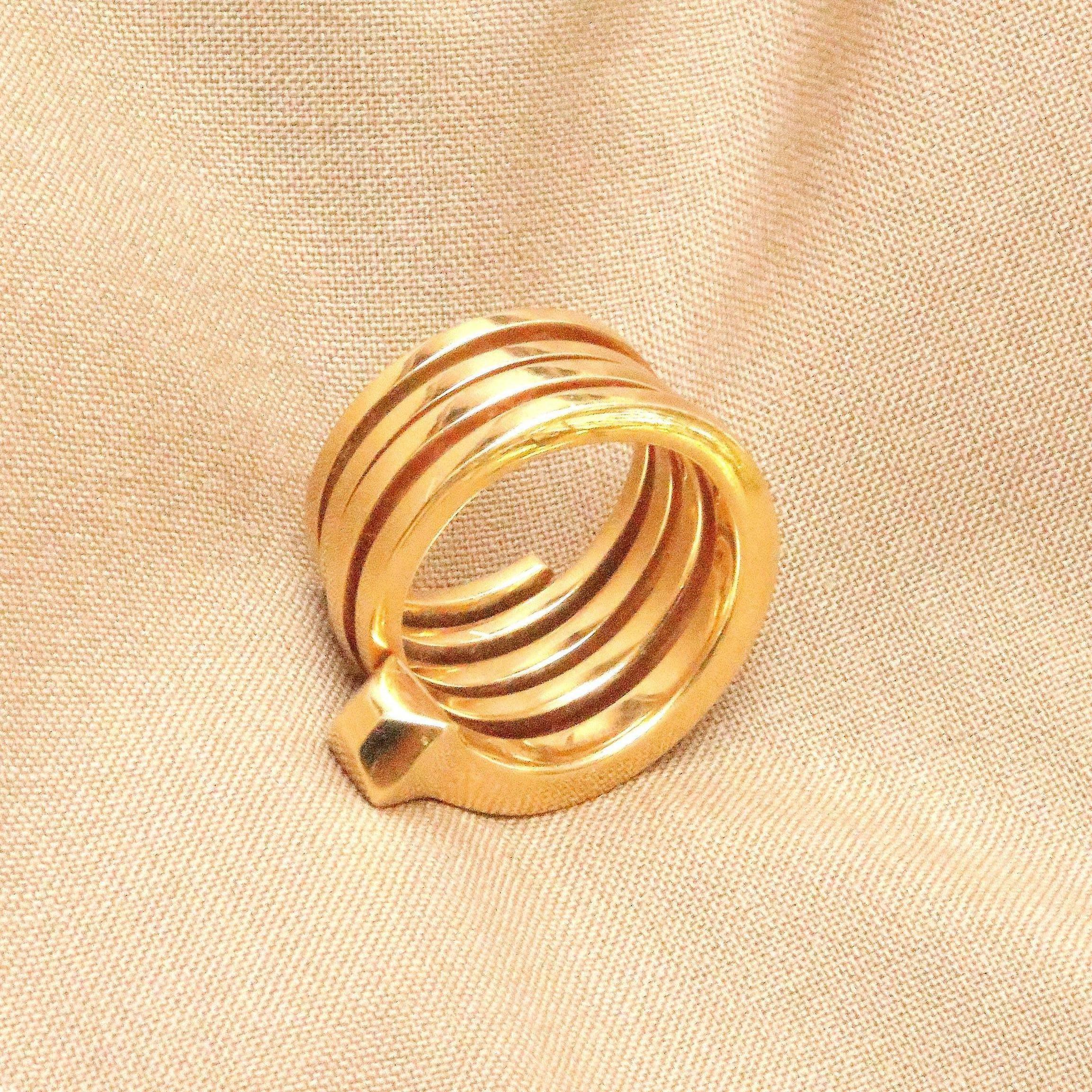 Gucci's appealing and creative version of the coiled nail ring. Created in 18k glistening gold. 

Ring size 5.
