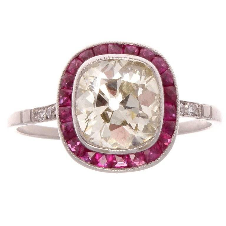 The halo setting is currently the most popular designed engagement ring. The creative use of rubies instead of diamonds gives the ring an added attractive dimension. Featuring an expertly cut 1.64 carat old cushion diamond that is L, M color and VS1