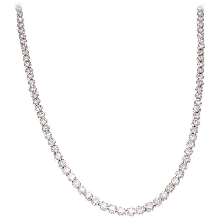 A refined elegance illuminates from this classic riviere necklace. Designed with 113 well matched diamonds weighing approximately 12 carats that are F-G in color and VS+ in clarity. Hand crafted in 18k white gold.

17 inches long.