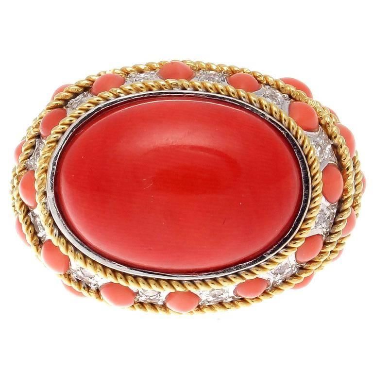 Big, bold and colorful designs. Influenced from the retro time period which made a reappearance in the 1970's and 80's creations. 

Featuring a vibrant cabochon cut reddish-orange coral that is perfectly complimented by cascading tear drops of