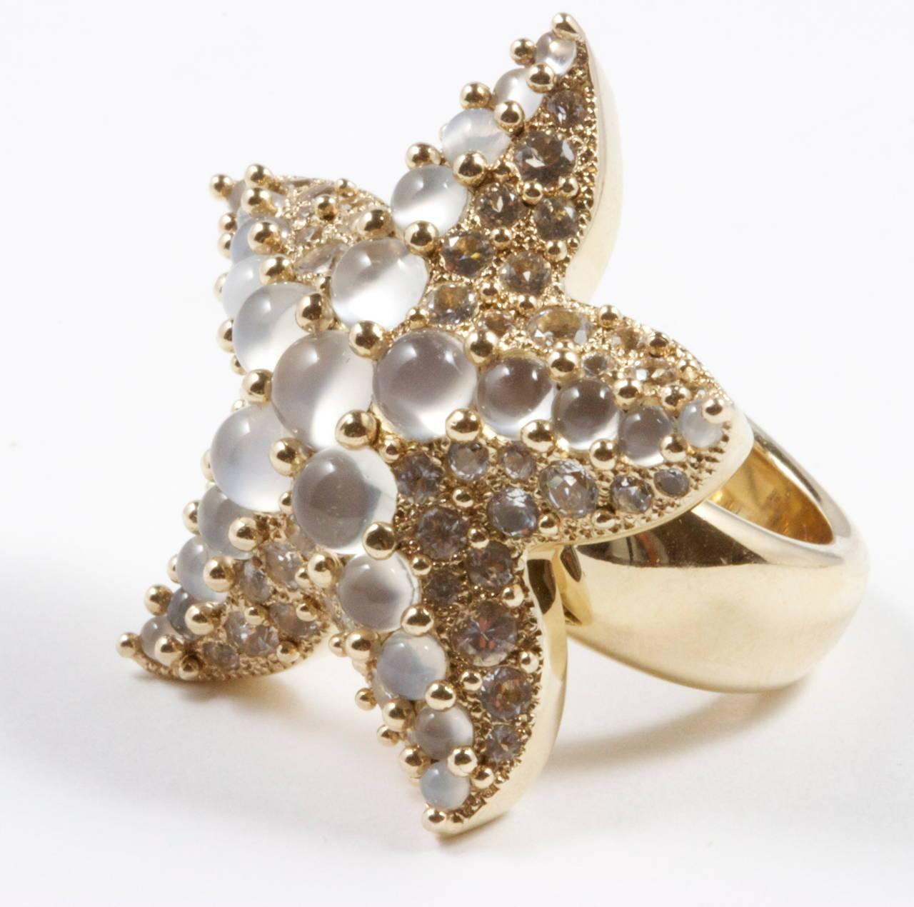 An Italian starfish by Pomellato. Big and whimsical creating a lovely and free flowing aquatic motif. The starfish is designed with large moonstones that are complimented by white topaz gemstones. Crafted in fine Italian 18k gold. Signed