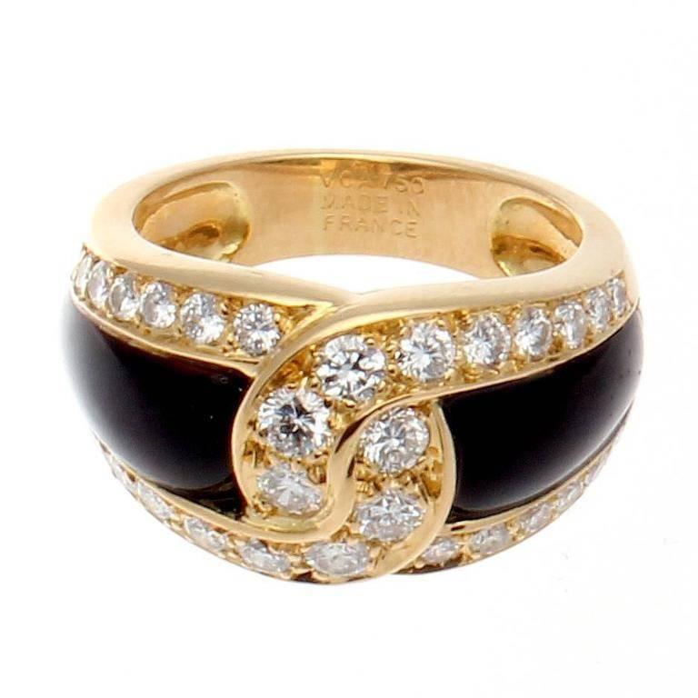 Van Cleef & Arpels, a long rich history of trend setting fashion that is still relevant today. The sleek black onyx has been joined together by the numerous near colorless diamonds. Crafted in 18k yellow gold. Signed VCA France and numbered.

Ring