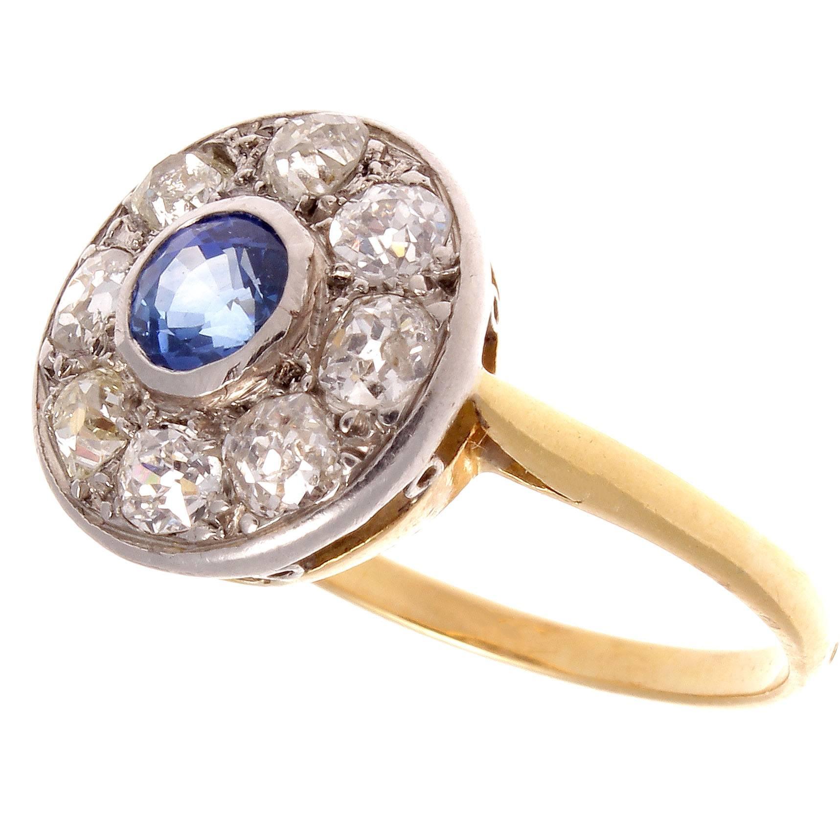 The belle epoque period was a time of increasing wealth and flourishing arts. This artistic creation paints color and balance with gemstones. Featuring a cornflower ceylon no heat sapphire that is orbited by 8 old cut diamonds. Crafted in platinum