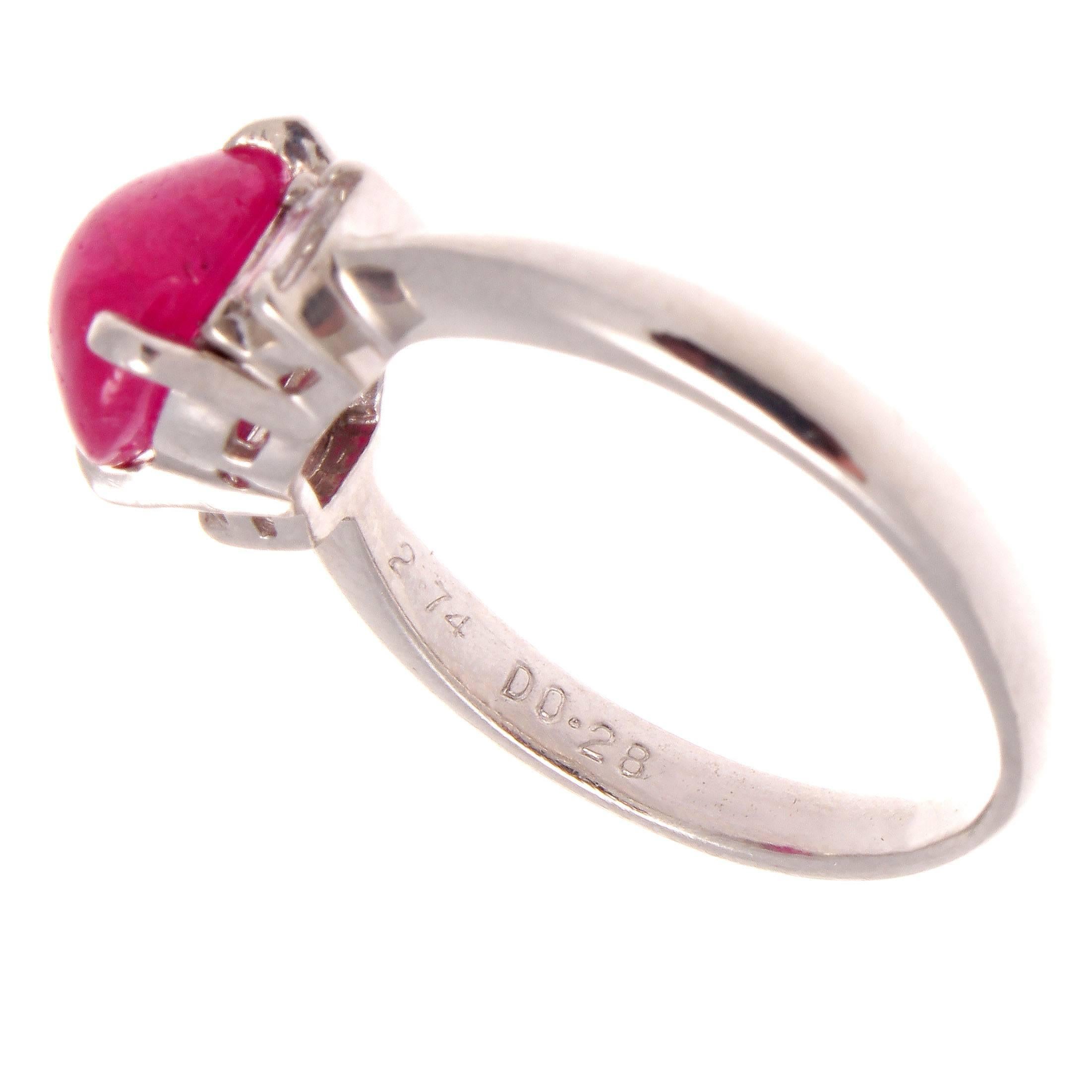 Leonardo da Vinci once said, simplicity is the ultimate sophistication. This ring expresses simplicity in a bright and beautiful manner. Featuring a 2.74 carat cabochon cut vibrant red ruby perfectly accented by two white, clean baguette cut