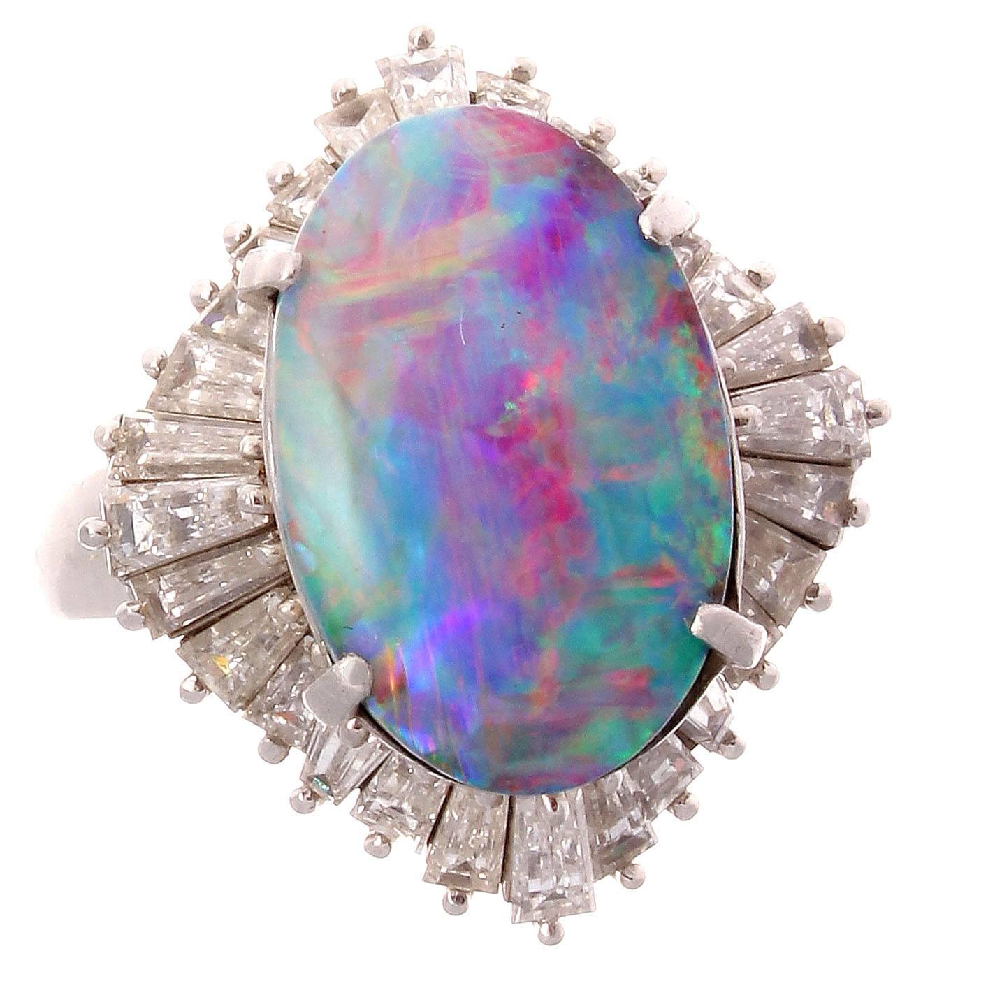 Hypnotic design that features a Crayola box of colors in the 3.45 carat black opal. Surrounded by a ballerina's twirling dress of diamonds. Crafted in platinum.

Ring size 6 and may easily be resized to fit complimentary with your purchase.