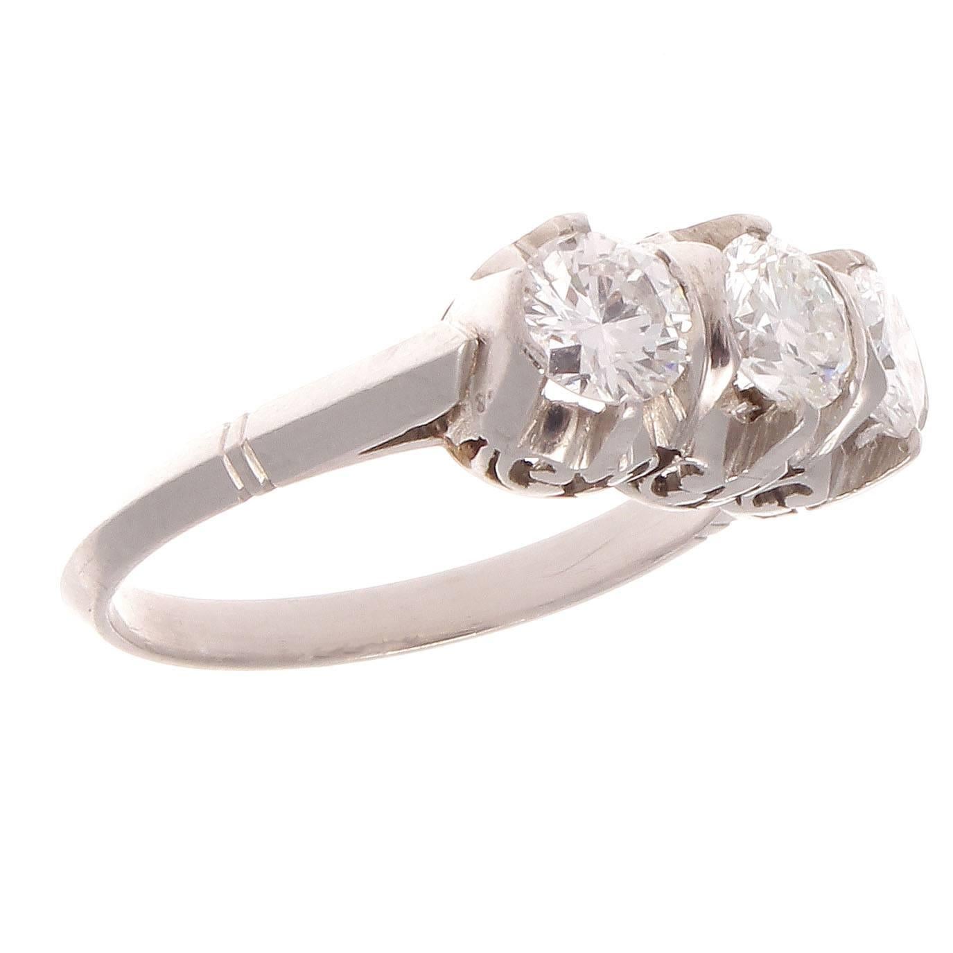 Inspired by the golden era of jewelry this wedding ring is timeless and will last the marriage in style with fond memories of the life changing event. Featuring 3 near colorless diamonds uplifted by swirling contours of hand crafted platinum.

Ring