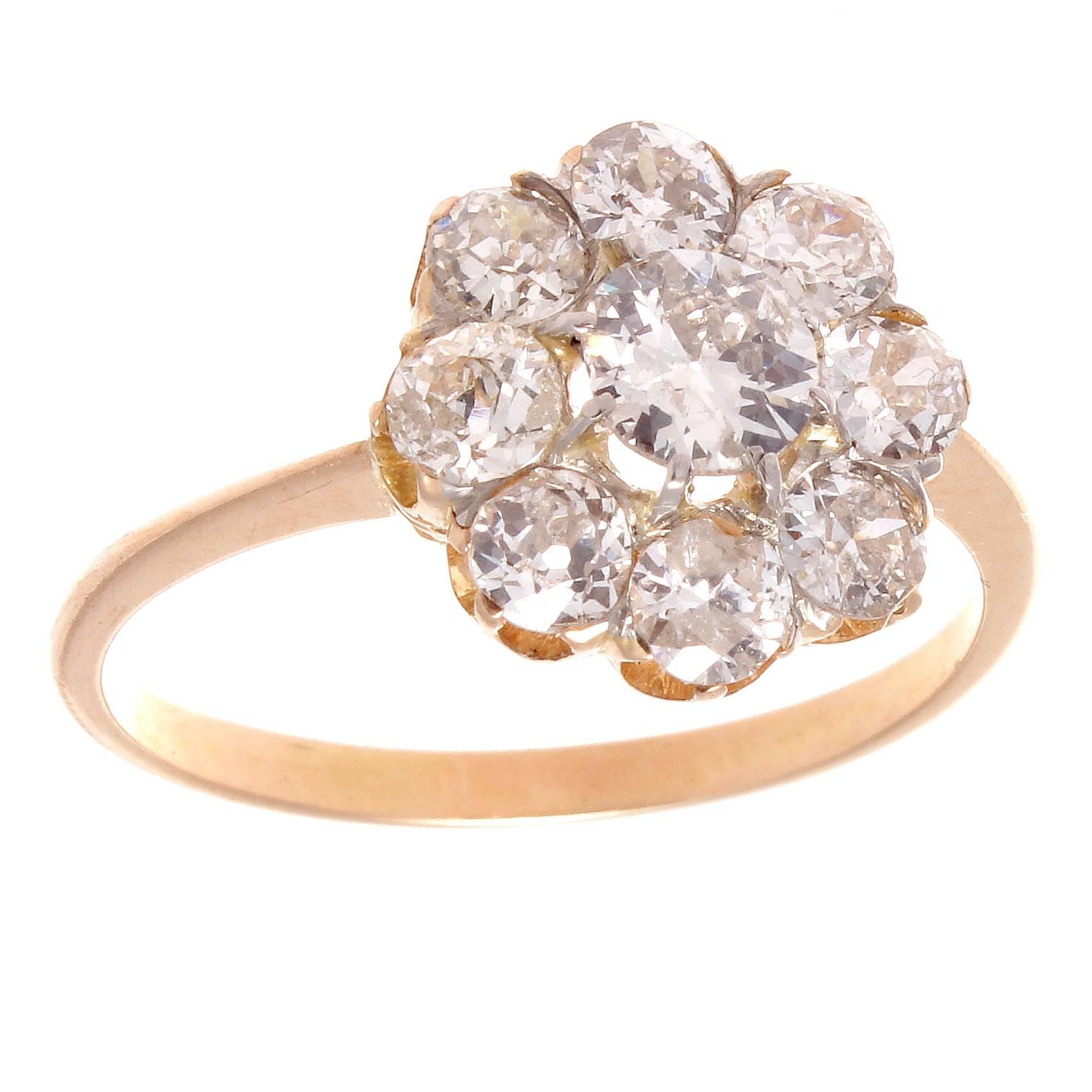 A creation of true beauty. It has long been thought that the cluster ring was originally inspired by the colorful flowers found in nature. Designed with 8 old European colorless diamonds surrounding the center diamond.  Hand crafted in 18k