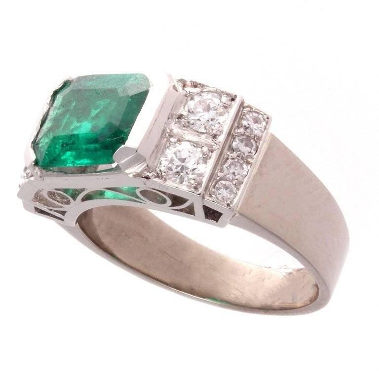 The emerald is a bright forest green exhibiting the color to the finest emeralds found in Colombia. The ring works equally well as an engagement or everyday ring and will always please your eye. With 12 white accenting diamonds. 

Ring size 6 and
