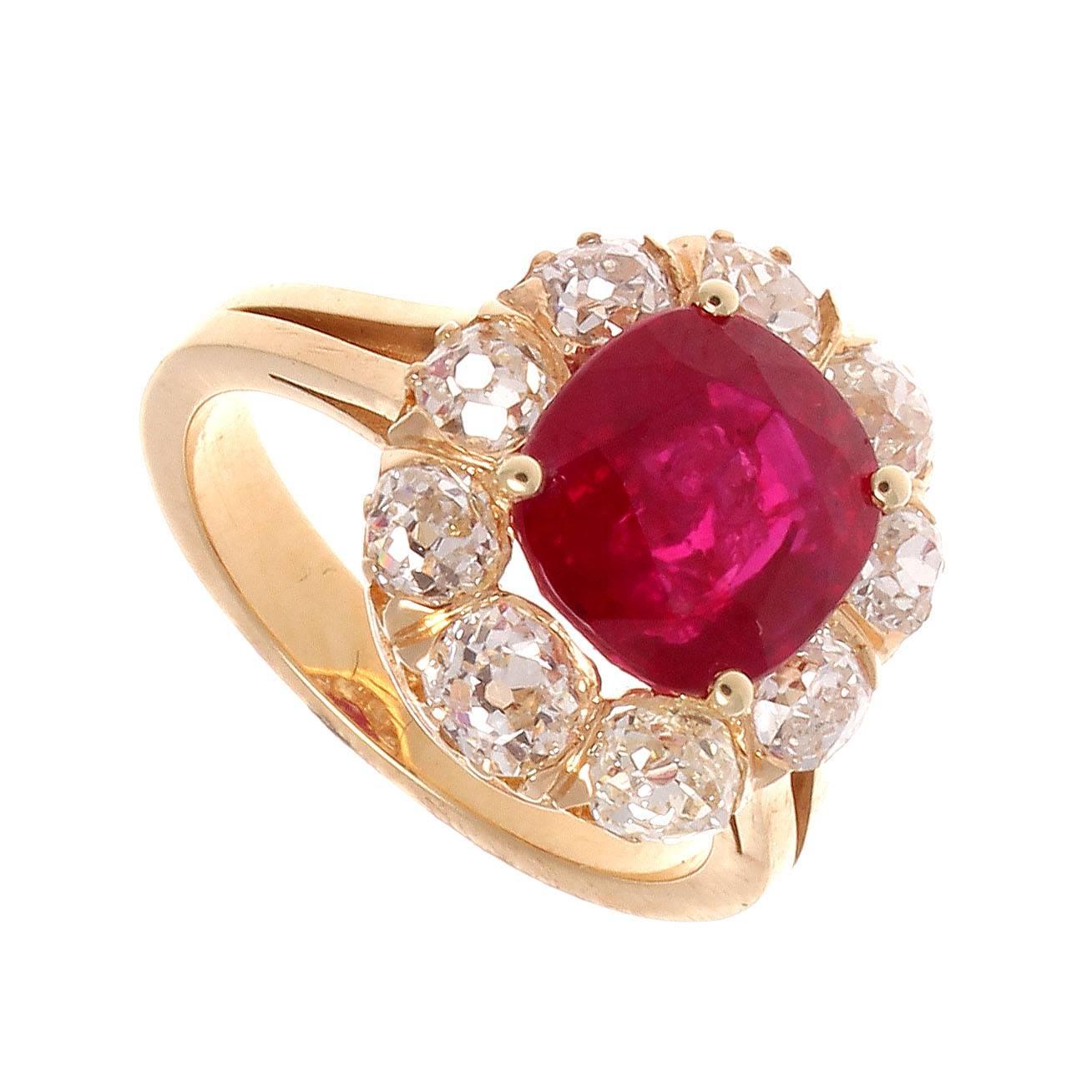 The iconic cluster ring, featuring one of the most sought after gemstones. No heat Burma rubies are rare and this ruby exhibits a sparkling pigeon blood color. The ruby color that is most sought after and that truly defines superior rubies. 

A