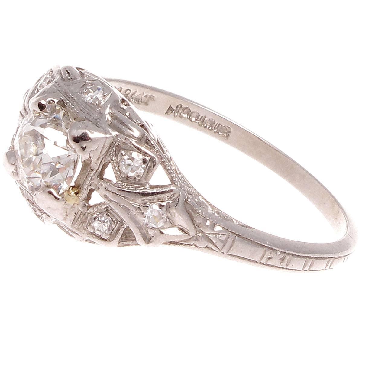 Beautifully crafted art deco ring that features symmetry and geometric shapes to create this picturesque design. Featuring an approximately 0.50 carat old european cut center diamond accented by numerous near colorless diamonds. Hand crafted in
