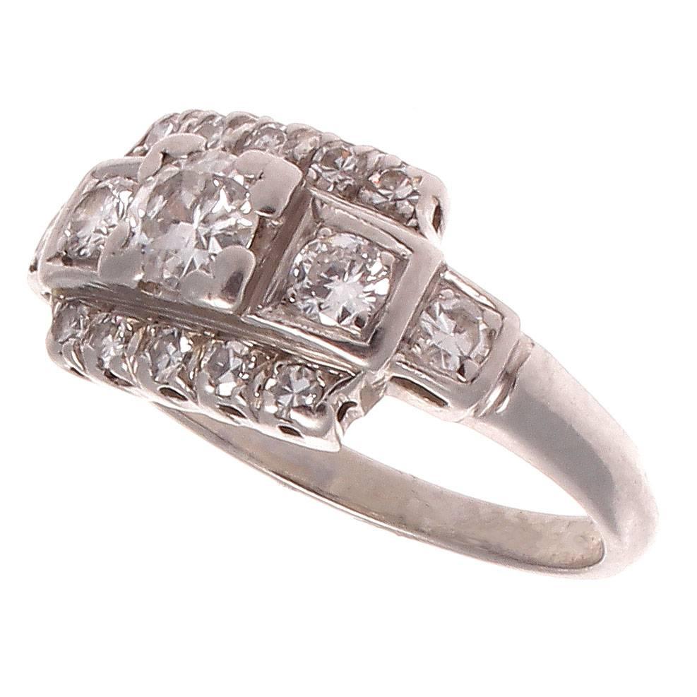 Elegance in its truest form. This art deco engagement ring is designed with a center diamond that weighs approximately 0.30 carats and is surrounded with layers of near colorless diamonds. Hand crafted in platinum.

Ring size 4-1/2 and may be