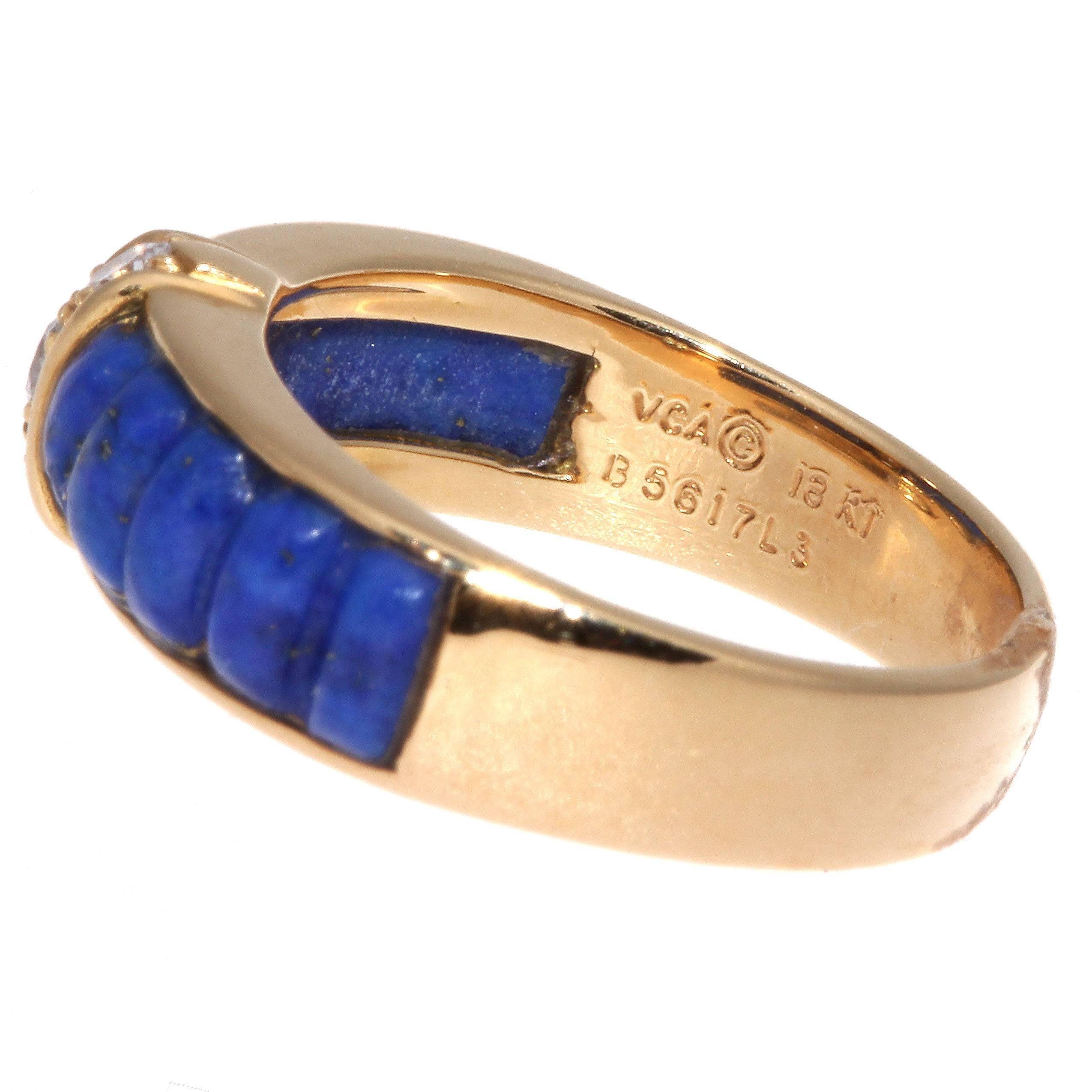 Van Cleef & 
Arpels, a long rich history of trend setting fashion that is still relevant today. This ring has been fashioned with glowing multi hued blue lapis lazuli that is complemented nicely by 3 near colorless diamonds. Crafted in 18k yellow