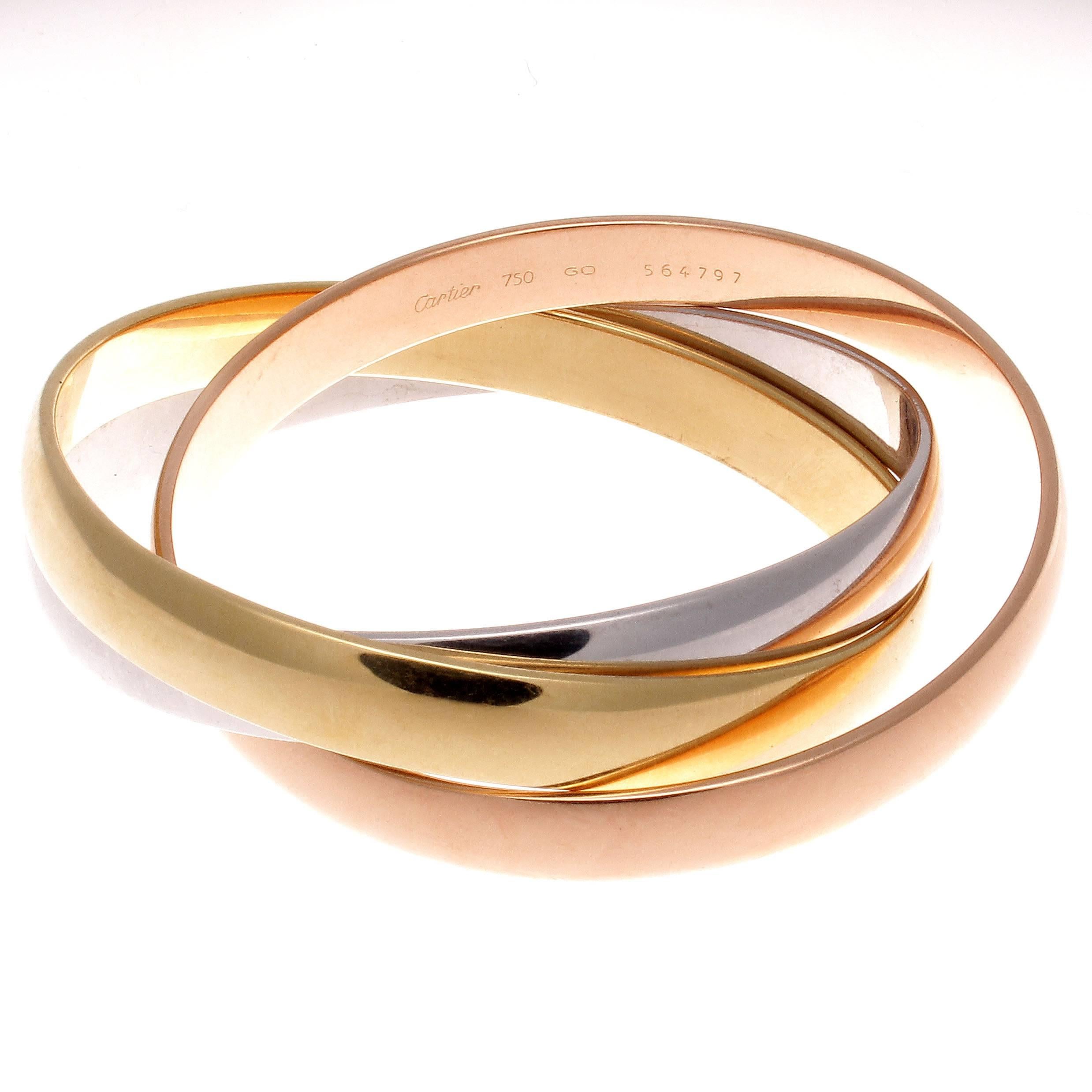 A timeless celestial design from Cartier. Created in the famous tricolor gold: pink gold for love, yellow gold for fidelity and white gold for friendship, intertwined in a display of unity and harmony. The bangle bracelets are designed in 18k,