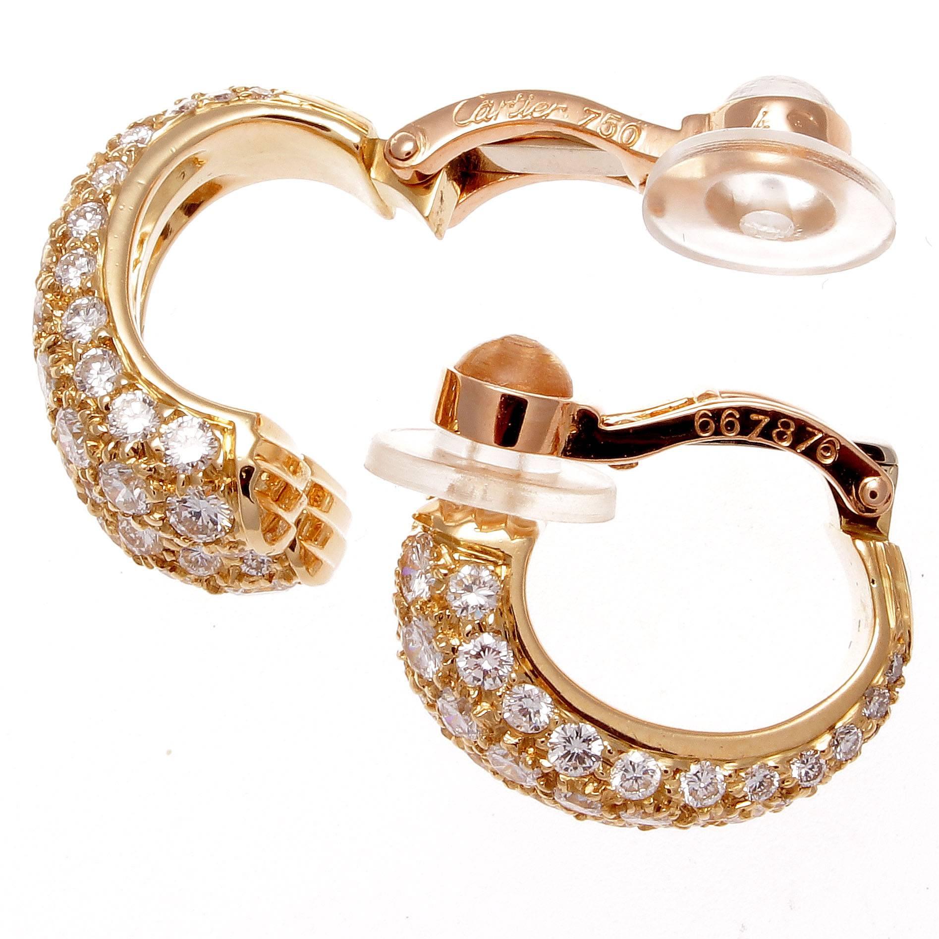 Cartier's creativity has always been rooted in its elegant designs. Designed with spiraling diamonds flowing down the double sided 18k gold earrings. Signed Cartier and numbered.