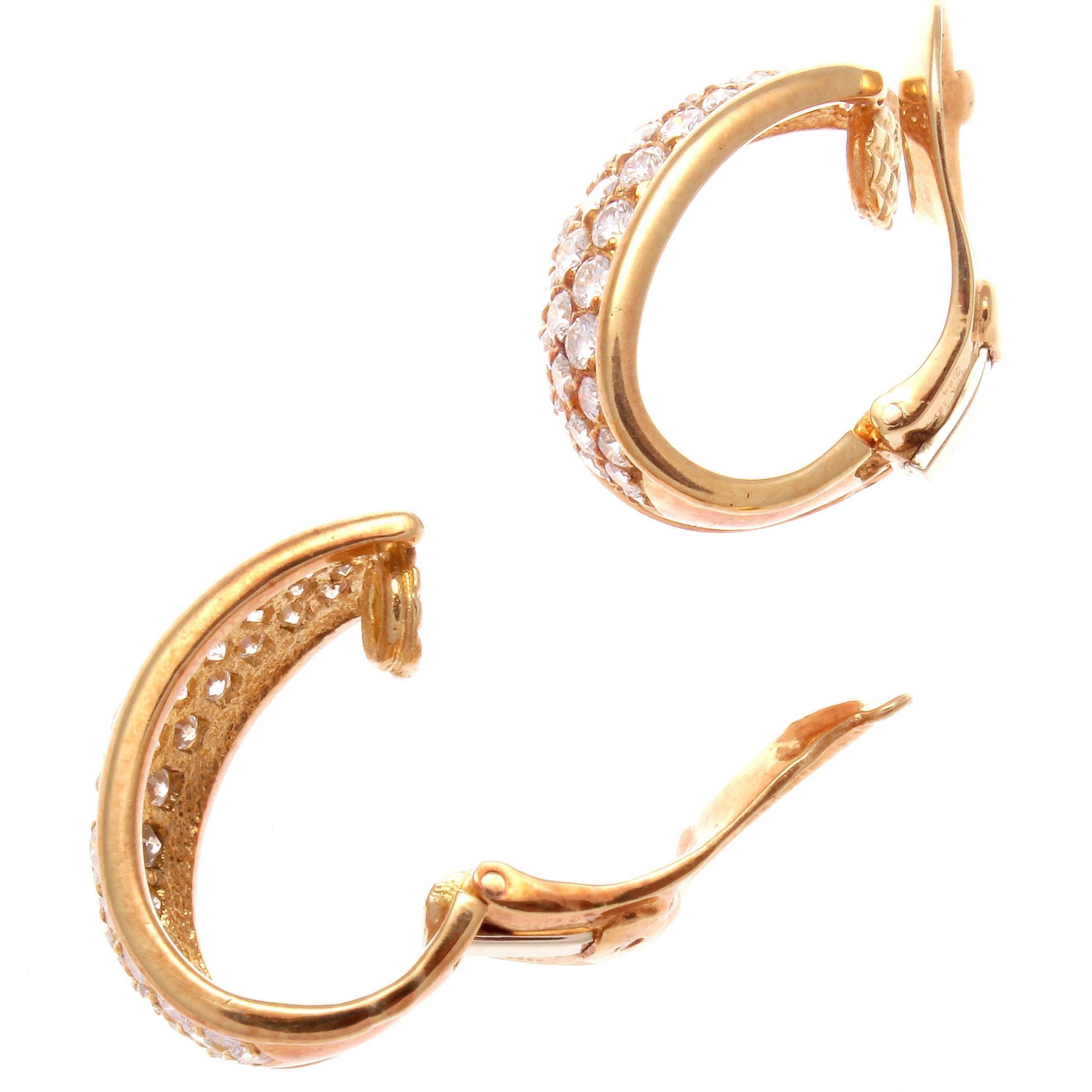 From the beginning to this day classic elegance is always present in the designs of VCA. Featuring colorless diamonds cascading down the smoothly crafted glistening 18k gold hoops. Signed VCA and numbered.