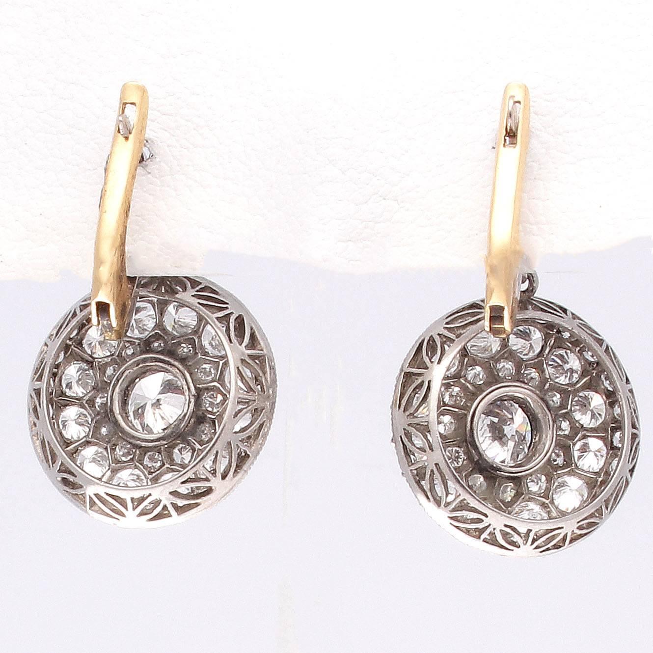 Embodying the style and allure associated with the art deco time period. Featuring numerous near colorless diamonds brilliant and  sparkling making up the dangling discs. Crafted in platinum.