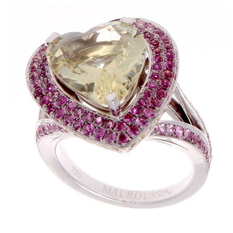 France has always been recognized for its style and fashion and the jewelry created there is no exception. The ring has been designed with a brilliant yellow endearing heart shaped gemstone that is nicely complimented by vivid pink sapphires and