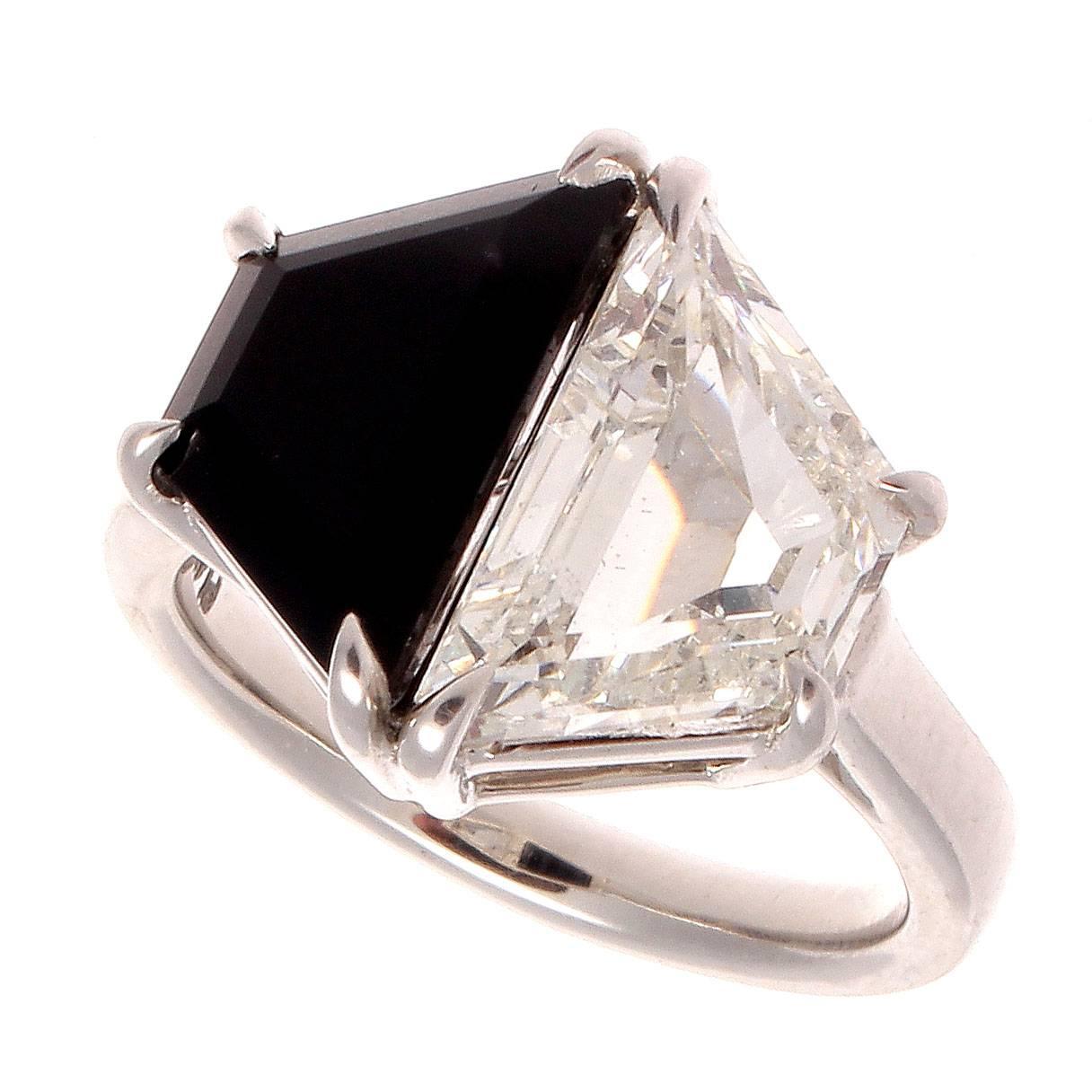 A modern creation of old world brilliance. The perfectly symmetrical design is reminiscent of the easily identifiable Art Deco ideology and elegance. Featuring a 2.27 carat GIA certified J color, SI2 clarity trapezoidal cut diamond that is perfectly