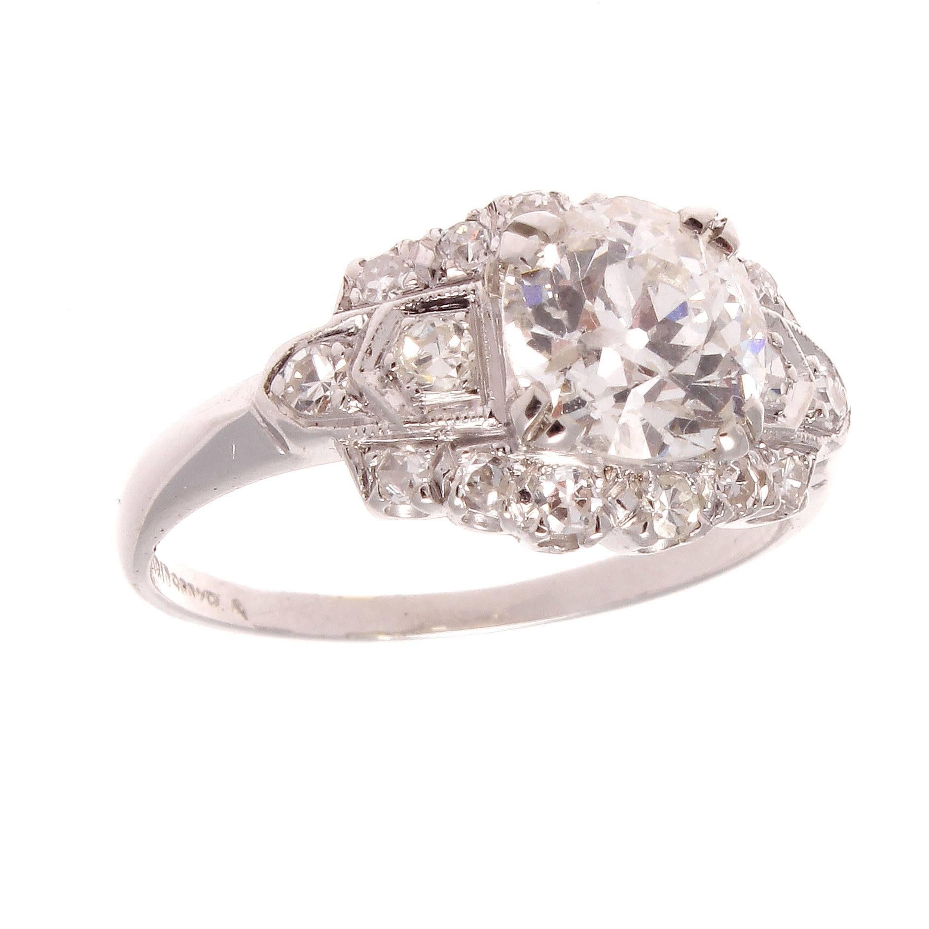 Unique symmetry along with a sense of elegance  created a time of luxurious extravagance  that is still unmatched.  Featuring a 1.16 carat old European cut diamond that is approximately H color, SI clarity and is surrounded by numerous colorless