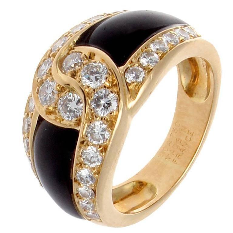 Van Cleef & Arpels, a long rich history of trend setting fashion that is still relevant today. The sleek black onyx has been joined together by the numerous near colorless diamonds. Crafted in 18k yellow gold. Signed VCA France and numbered. 