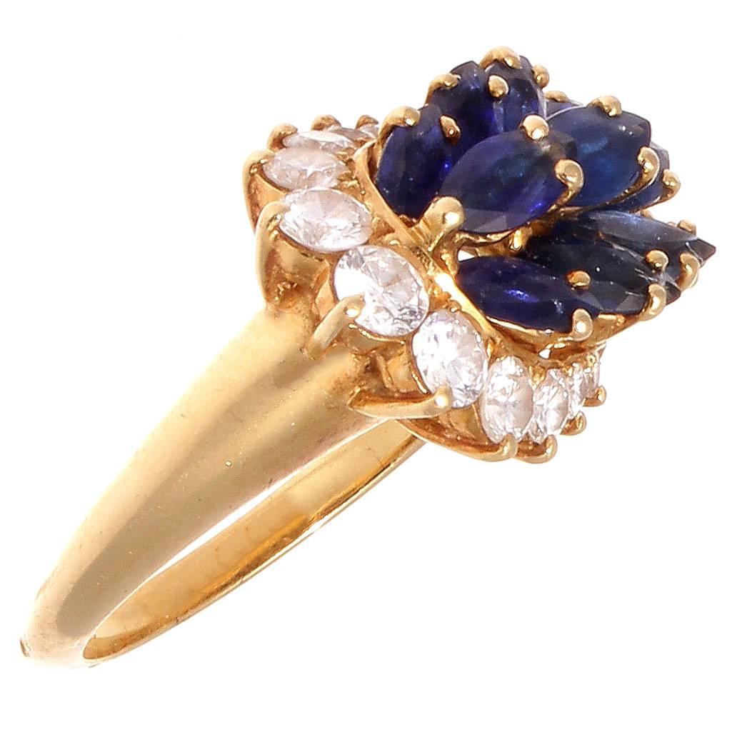 Modernistic design is what defines Piaget and their artistically creative jewelry. Fashioned with numerous illuminating royal blue marquise cut sapphires elegantly surrounded by a horseshoe of sparkling diamonds. Crafted in 18k yellow gold. Signed