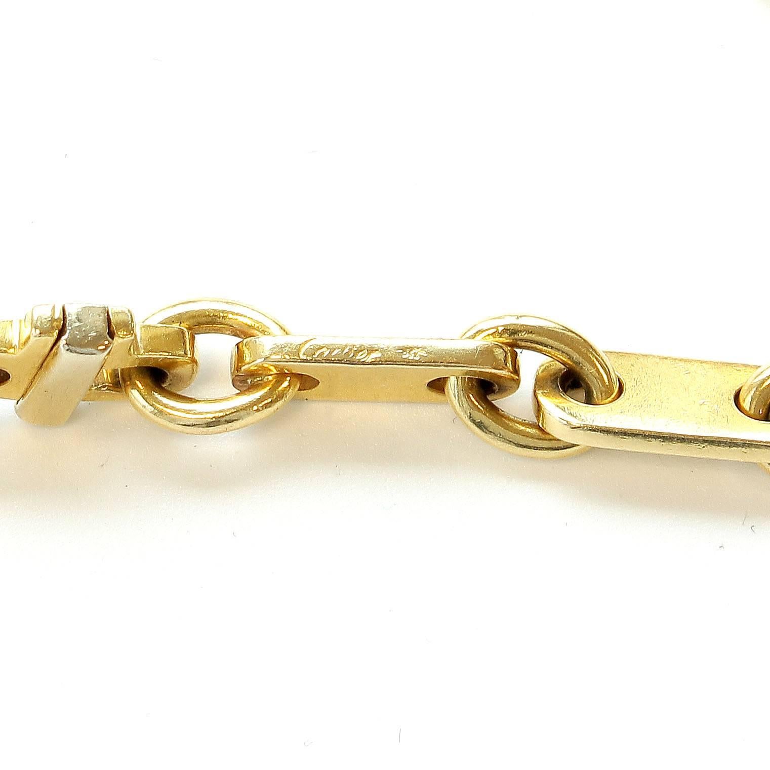 Simply Cartier. Elegant links of glistening 18k yellow gold interlocking to create this bracelet. Signed Cartier.