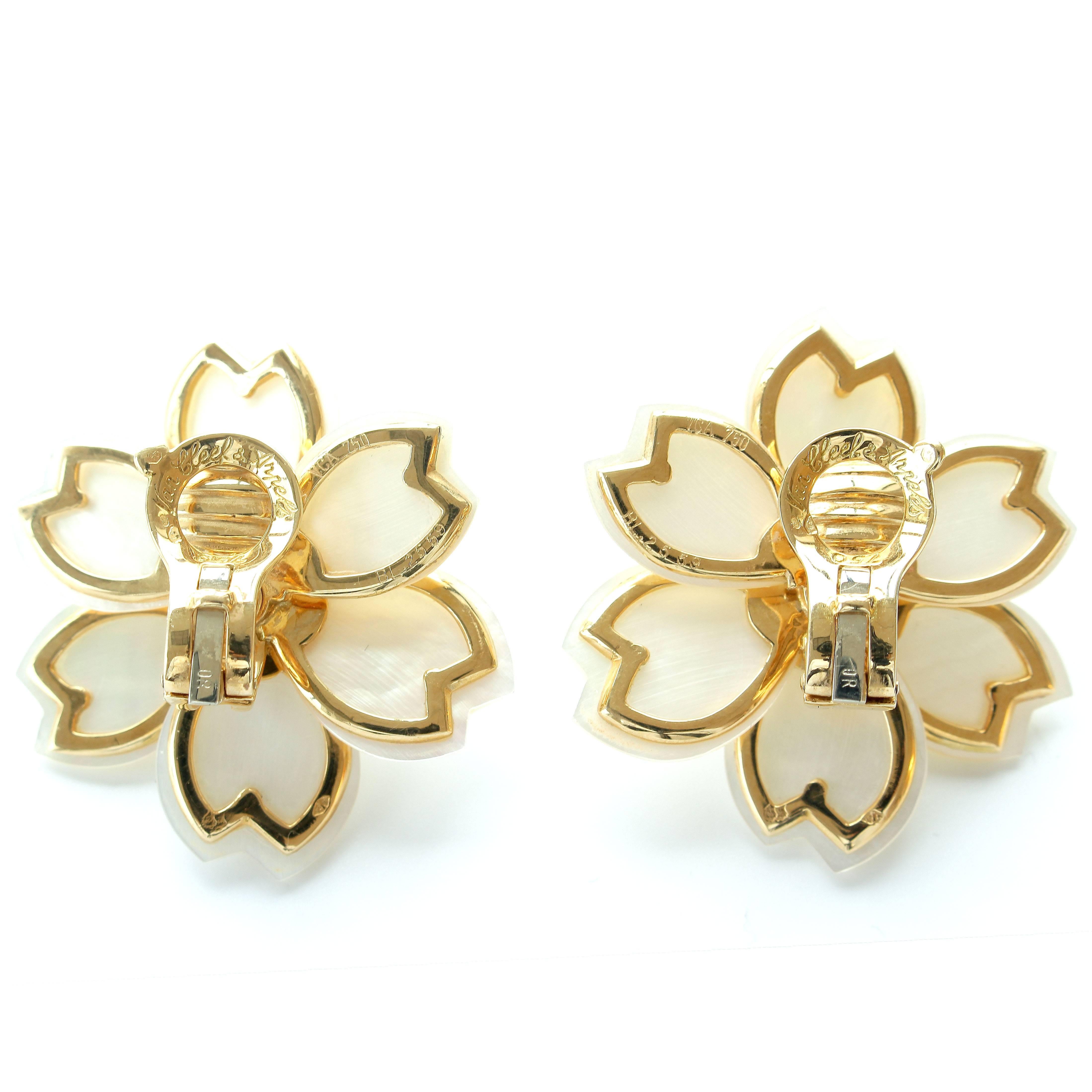 Blossoming brilliance by Van Cleef & Arpels. Designed with shinning white mother of pearl petals and perfectly placed colorless diamonds to create the flower motif. Crafted in 18k yellow gold. Signed VCA, numbered and stamped with French