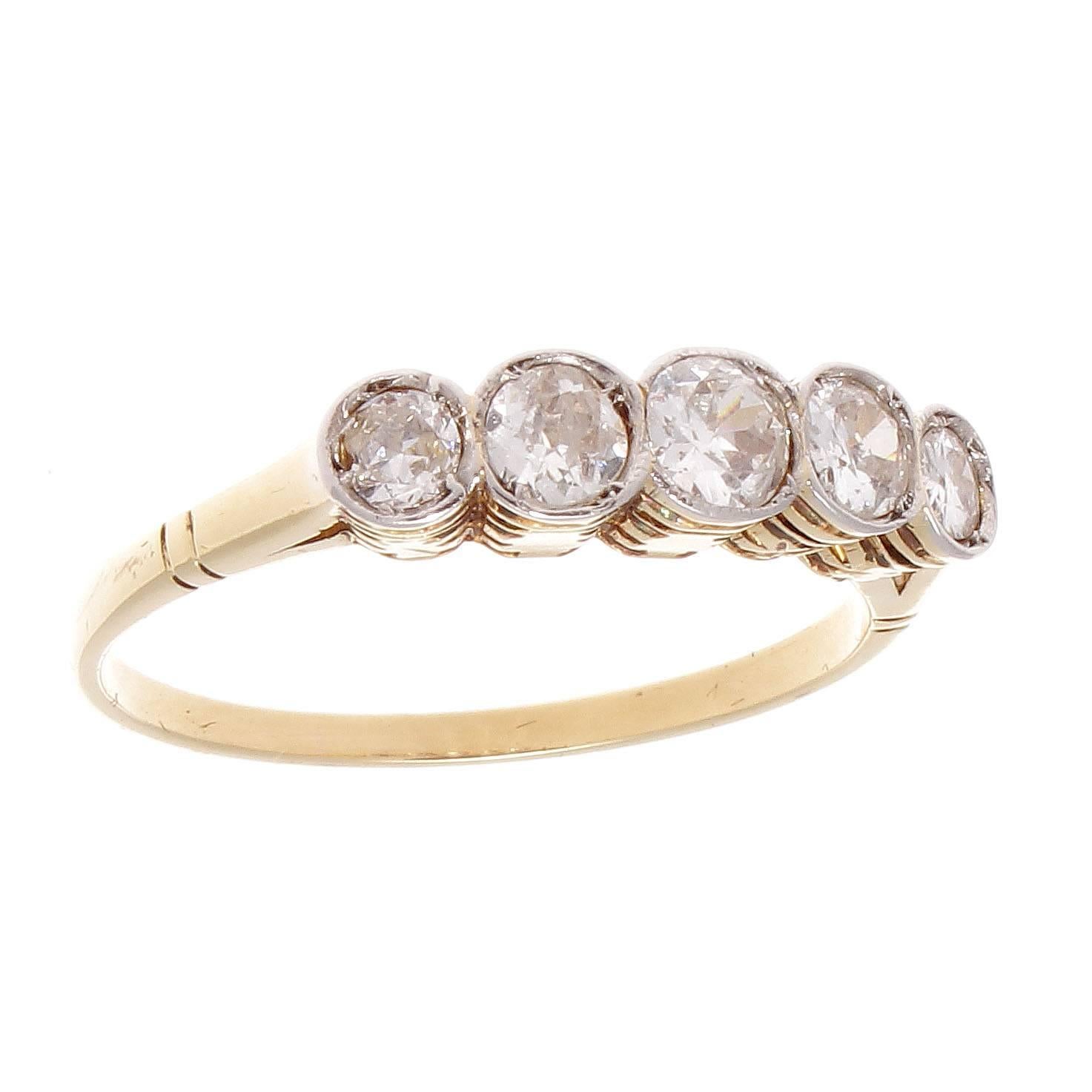 Elegance and beauty radiates from this classic five stone ring that is inspired by the 19th century Belle Epoque era. Designed with five old European cut diamonds weighing approximately 1 carat. Crafted in platinum and 18k gold. Ring size 6 and may