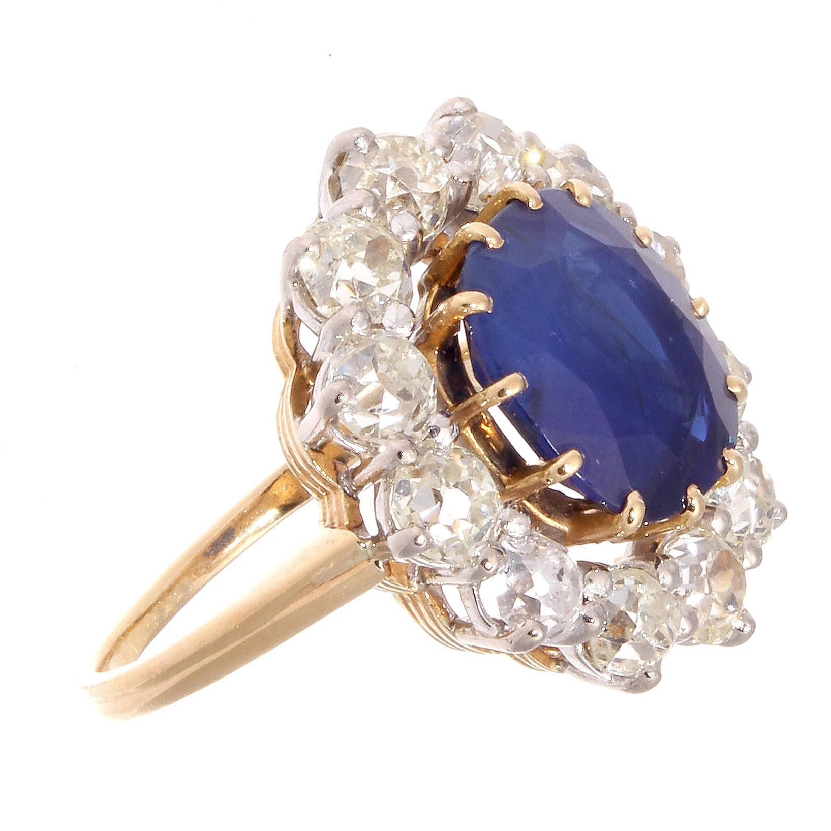 A lovely combination of glamour and style, infusing the classic halo ring with extravagant cocktail design. Featuring an approximately 5 carat lovely royal blue sapphire both deep and vivid by definition and is certified by GIA as Cambodian origin