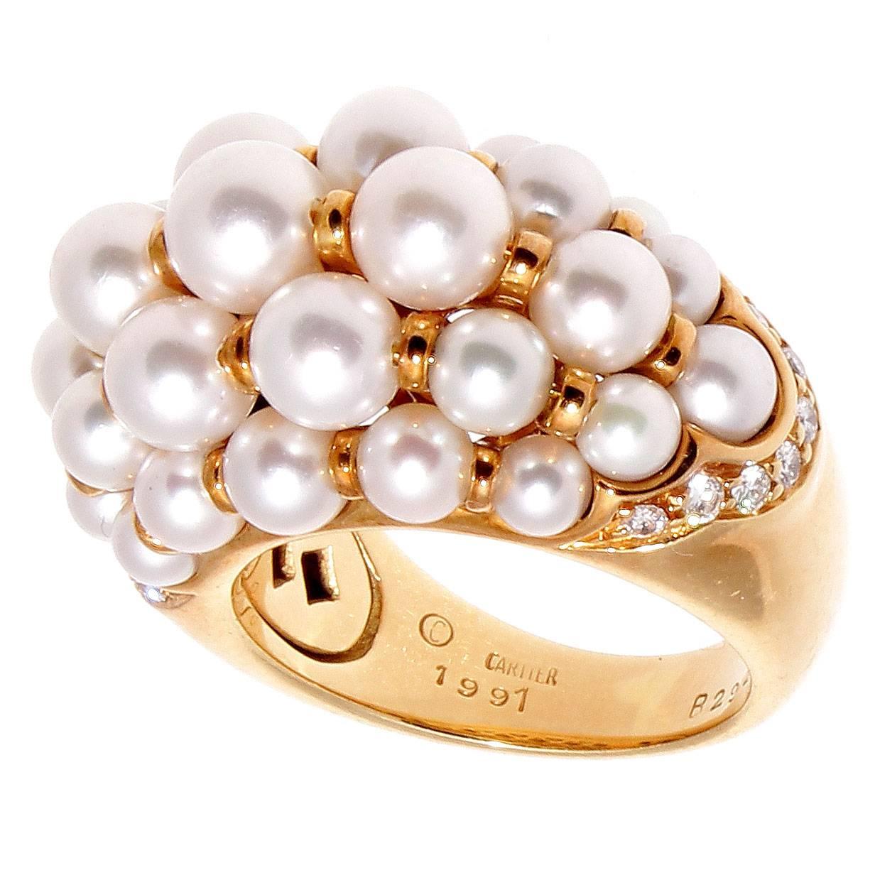 Cartier has a way to bring impossible to fruition. Pure white design to create this elegant ring that can be worn to the ball with a gown or to the grocery store with a pair of jeans. Featuring a dome of precious rich glowing white pearls that is