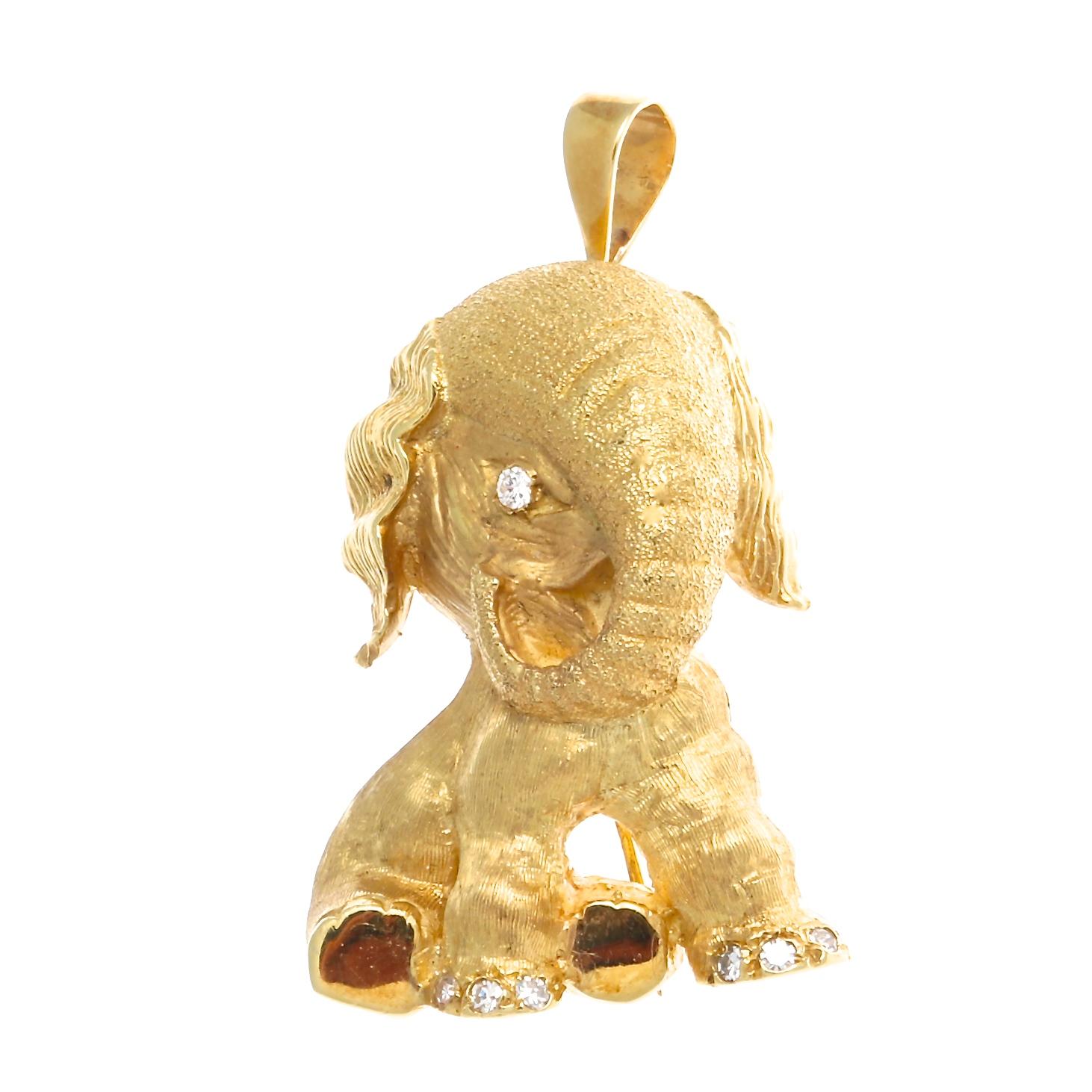 The Tiffany elephant symbol of good luck, strength and honor. Textured 18k gold and perfectly placed diamonds bring this motif to life. Signed Tiffany & Co. 1-1/2 inches long x 1-3/16 inches wider.